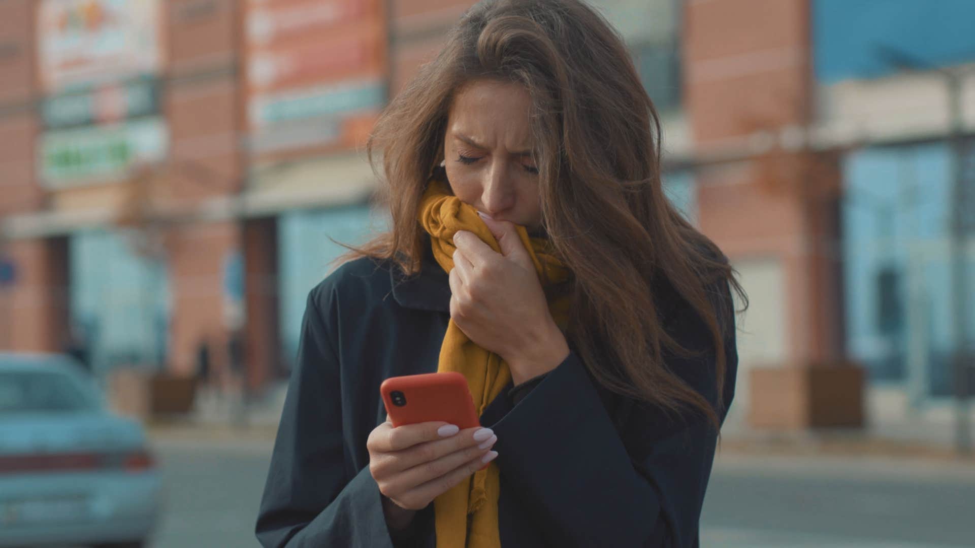 woman holding her nose because of a smell outside
