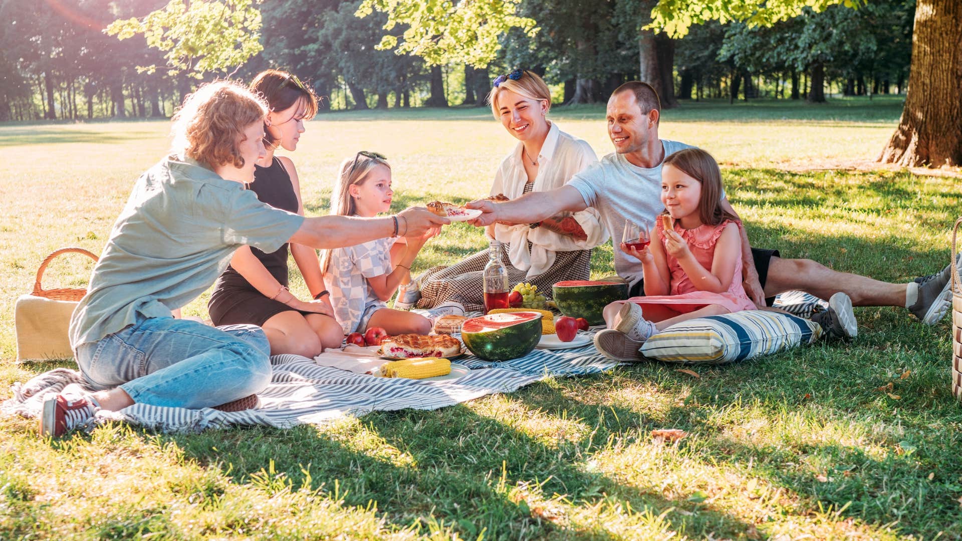 family having a picnic outside together