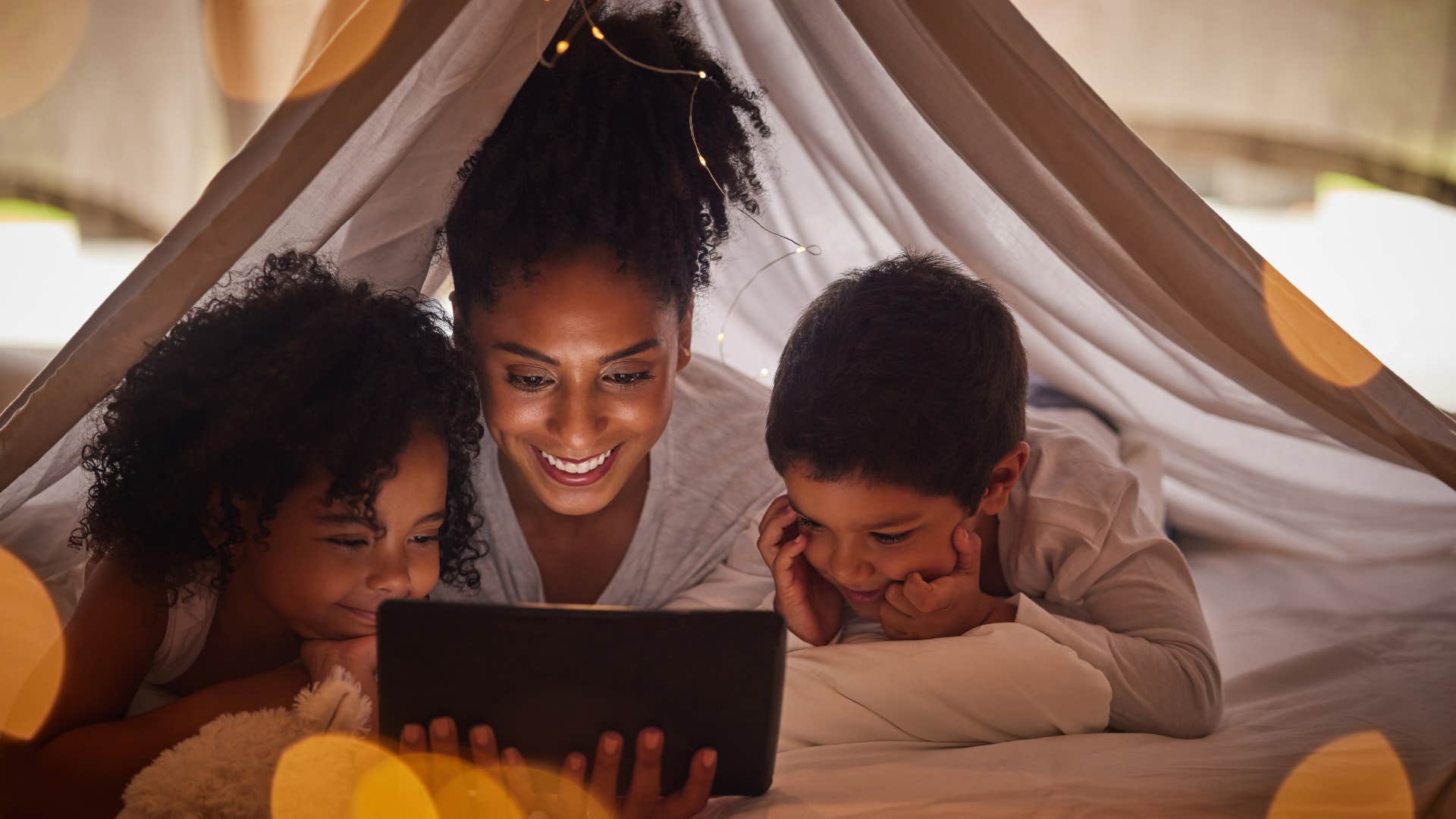 mom and kids having a sleepover in the living room