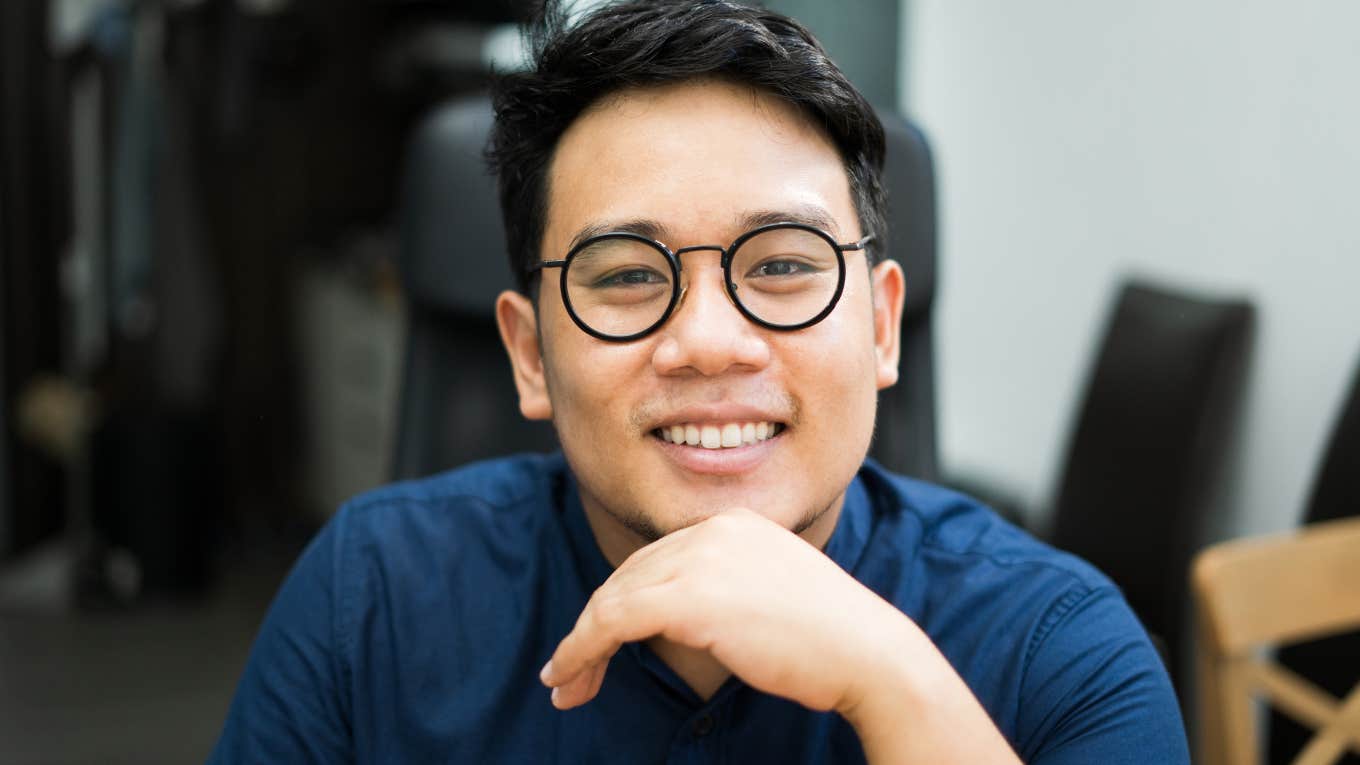 smiling young man thinking about how parents raised him right