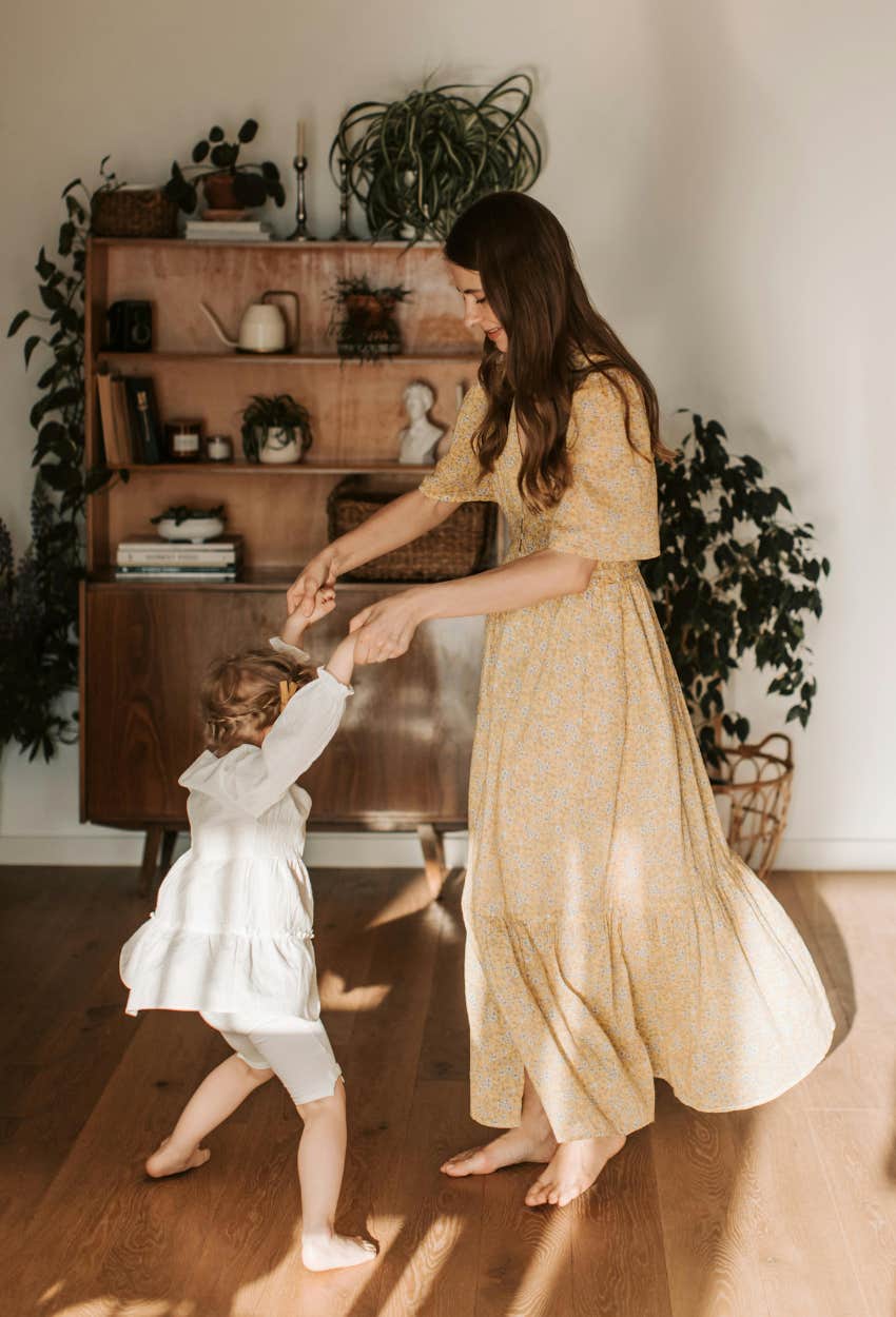 Woman happier dancing with her young daughter