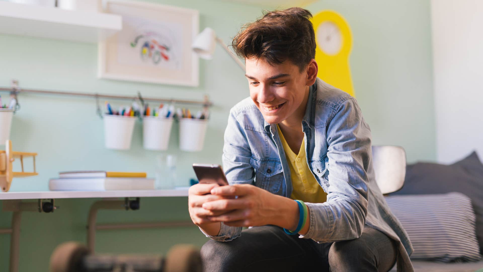 teenager texting while sitting as texting is considered culturally normal in the younger generations
