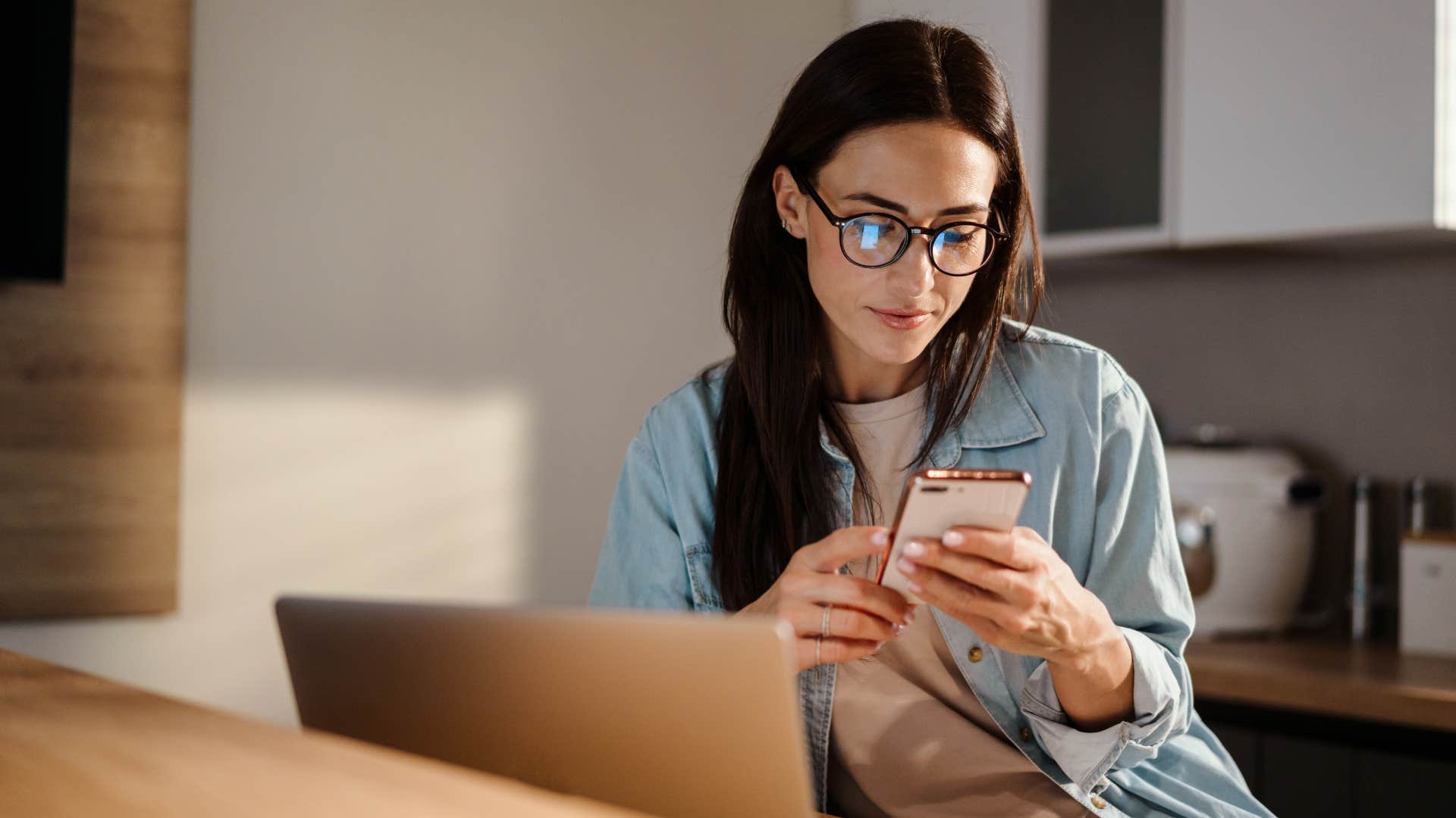 woman in glasses needing more time to think as she scrolls on her phone