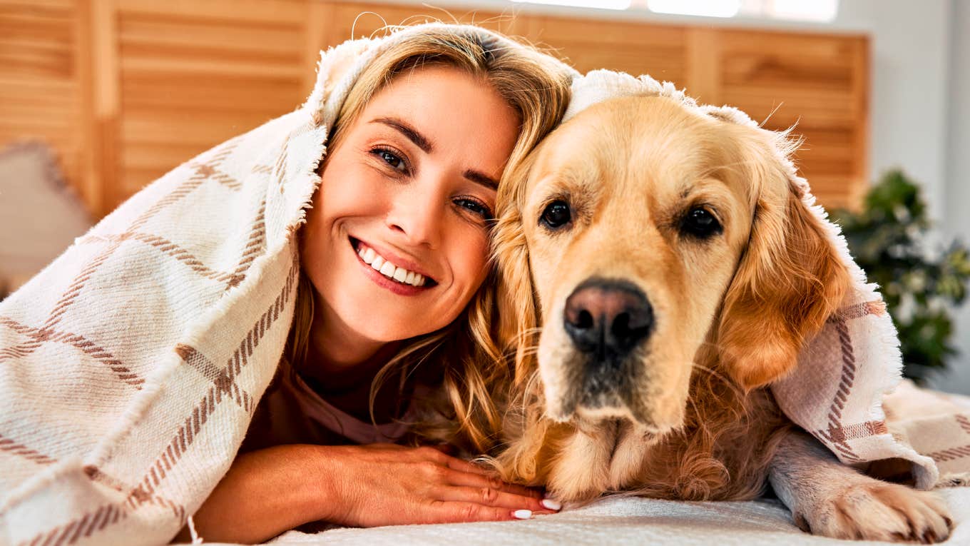 People Who Share A Bed With Their Pet Usually Display These TK Traits, According To Psychology Person sharing a bed with their pet.