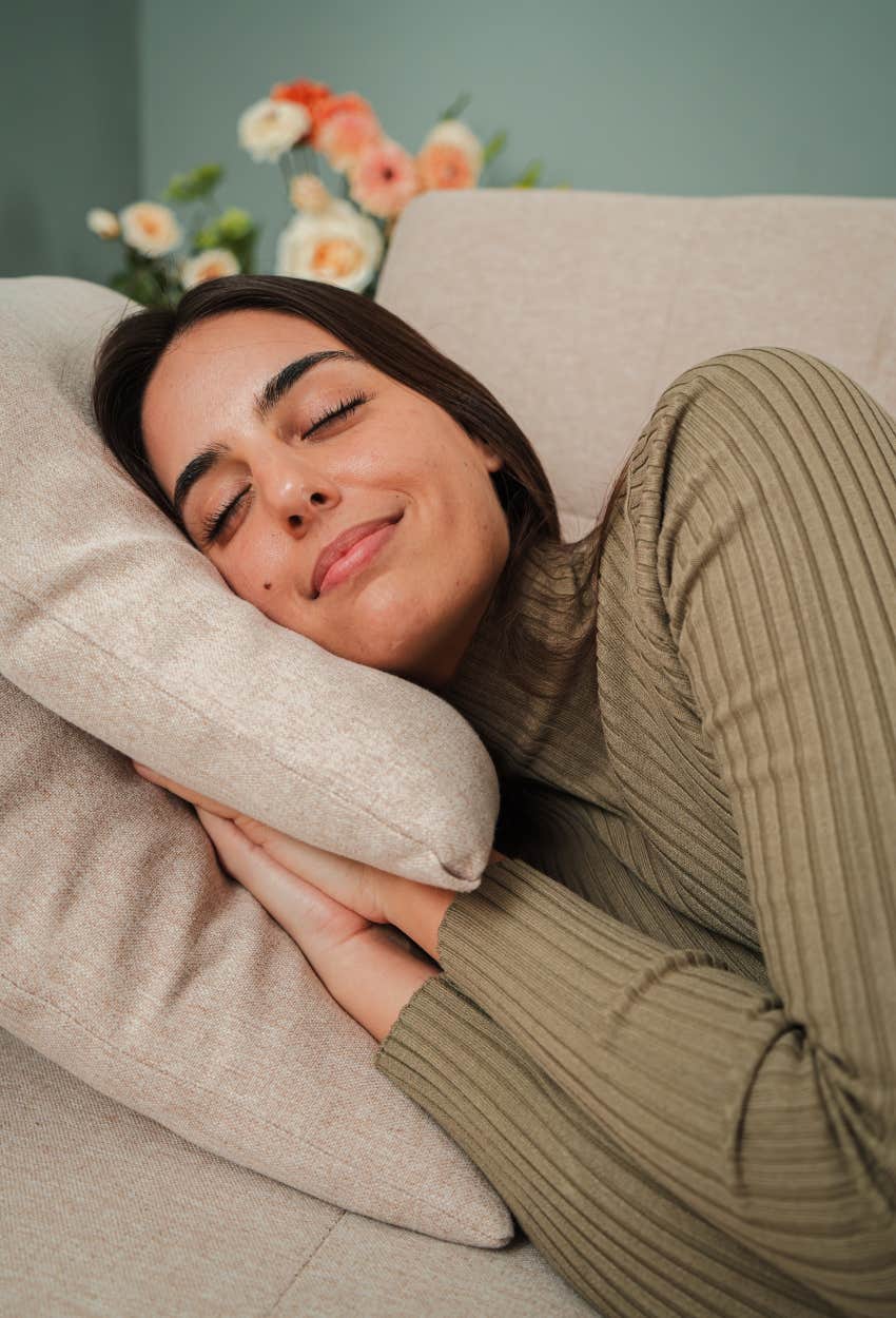 woman smiling because she is napping and happy