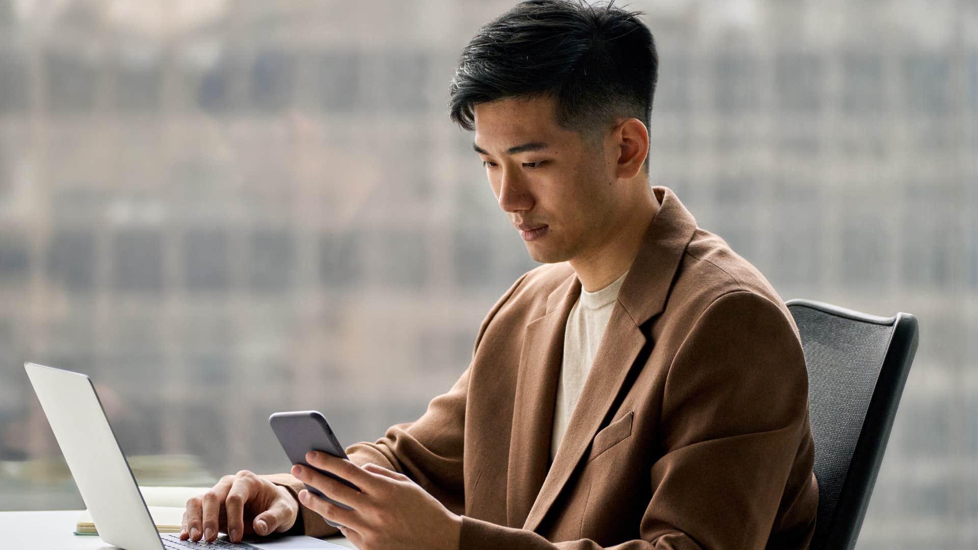 Disciplined man working and looking at his phone.