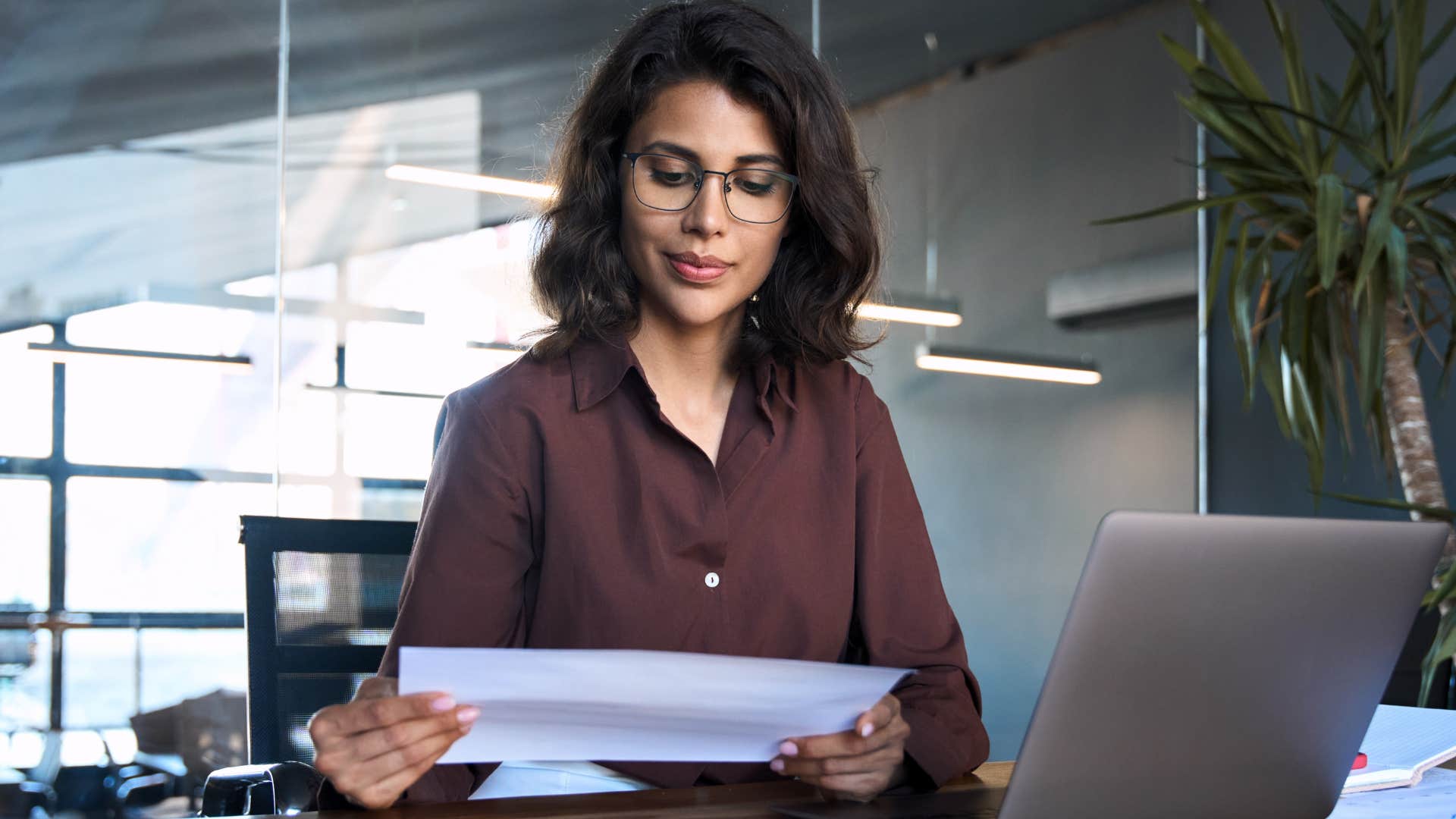 Detail-oriented woman working at her desk.