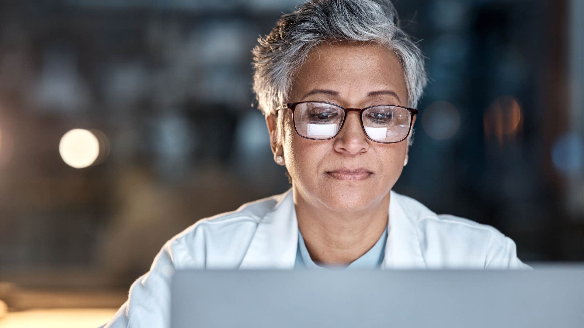 Woman who doesn't procrastinate working on her laptop.
