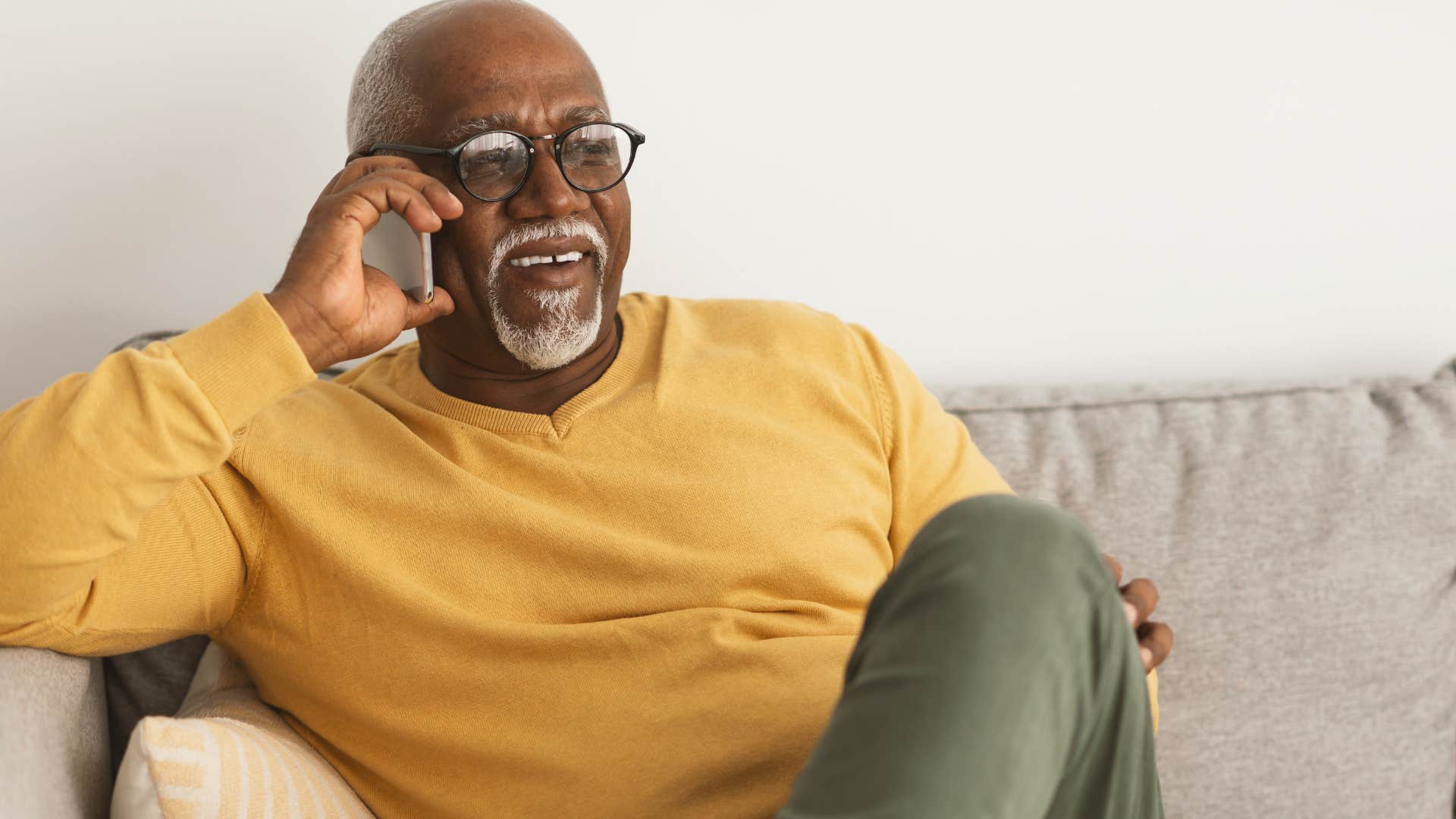 older man who's more self-aware talking on the phone