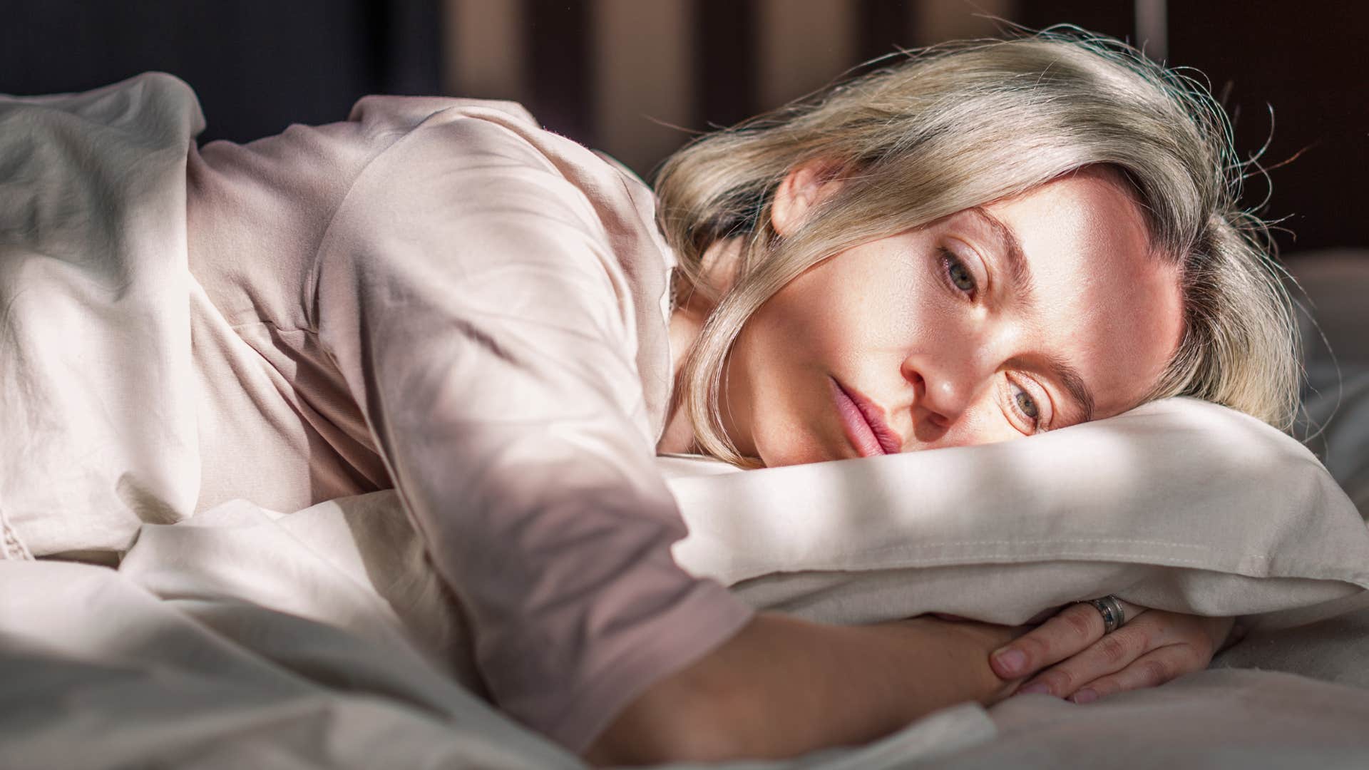 woman telling herself shes tired laying in her bed