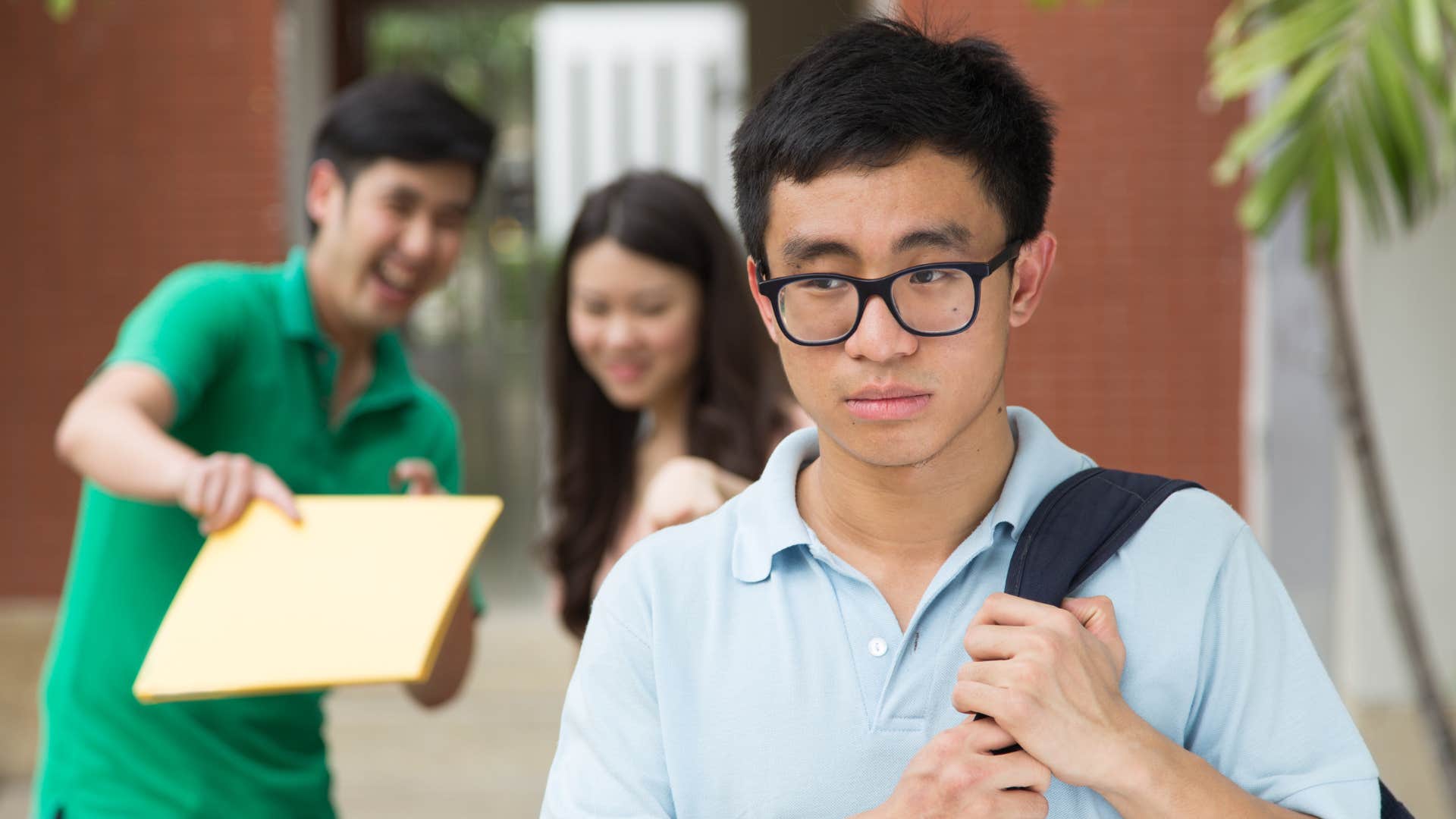 man in green shirt and woman pointing at man in blue shirt saying wow you actually like that
