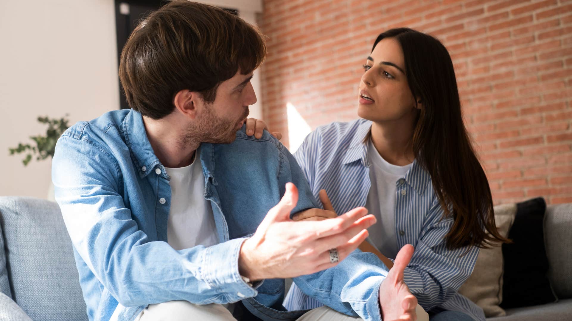 man in blue shirt shrugging partner off as he says i don't have to explain myself to anyone