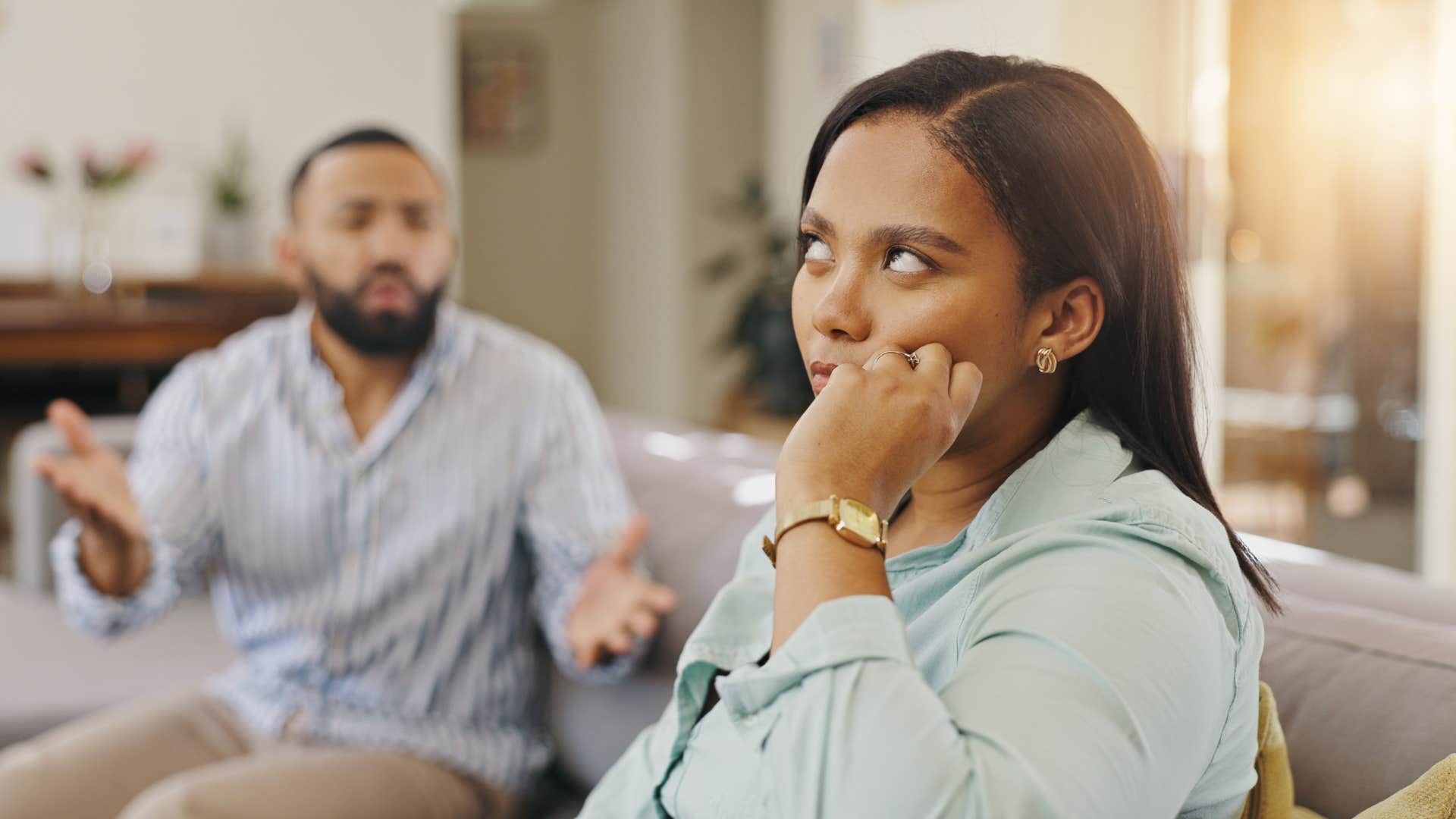 an unhappy husband tries to get his wife to listen to him but she just rolls her eyes