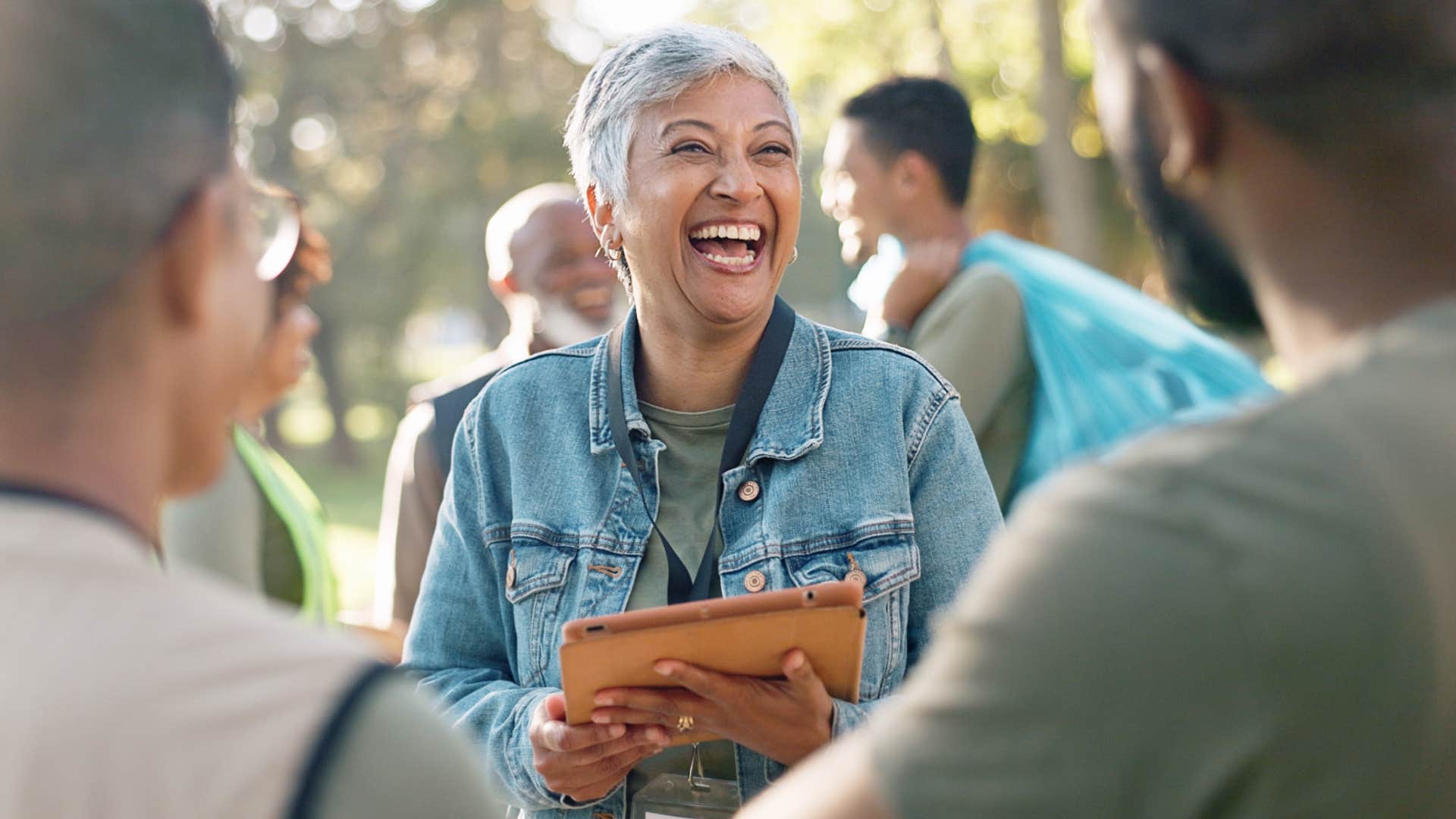 smiling woman saying it's not my first rodeo to friends