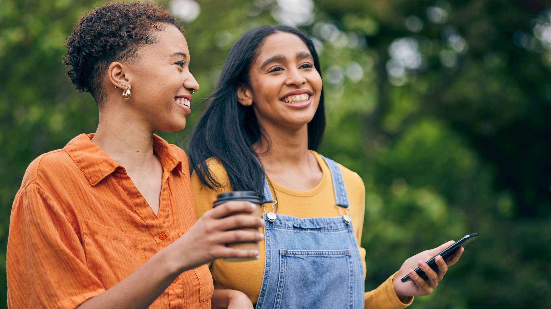 woman smiling and saying that's my jam to her friend hearing a song