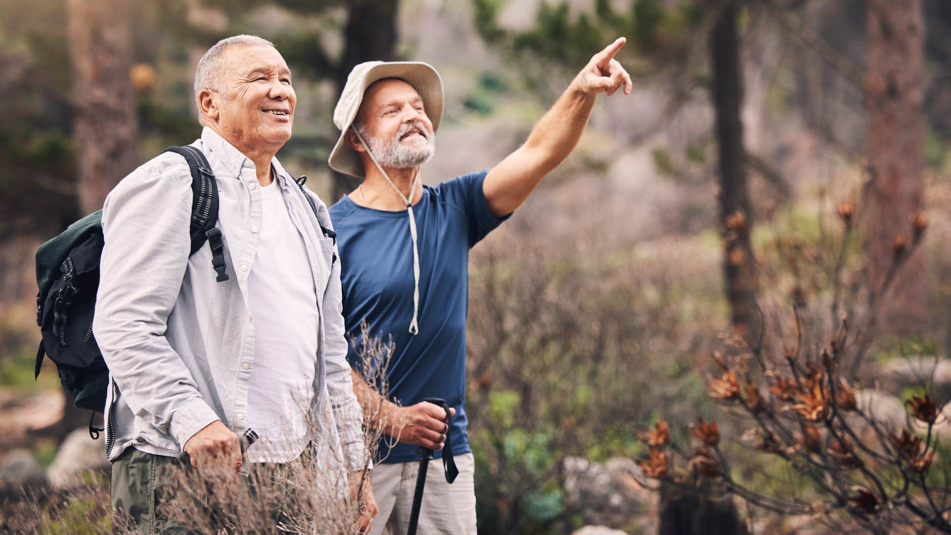 couple hiking pointing over yonder