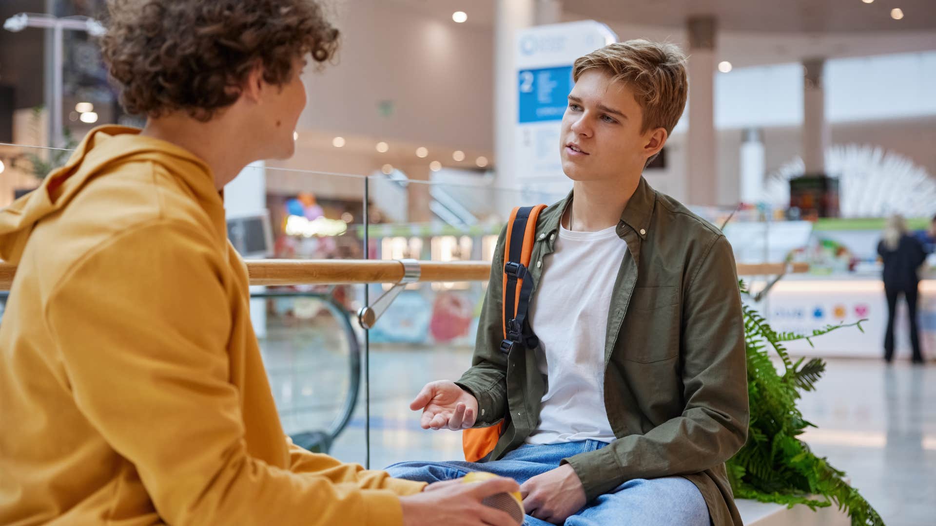 boy asking his friend if he's mad at him