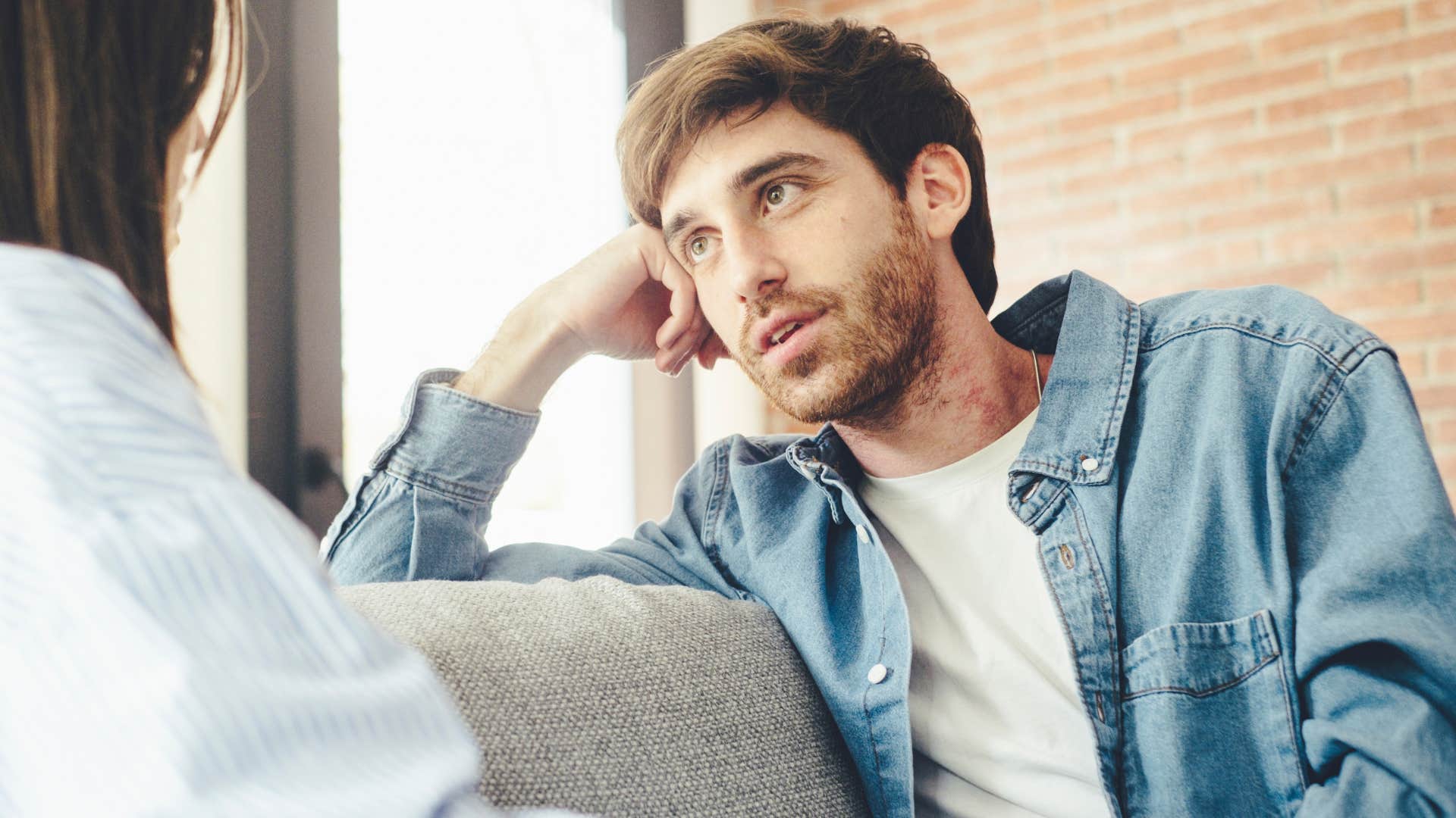 Man saying "I don't care" to his partner at home.