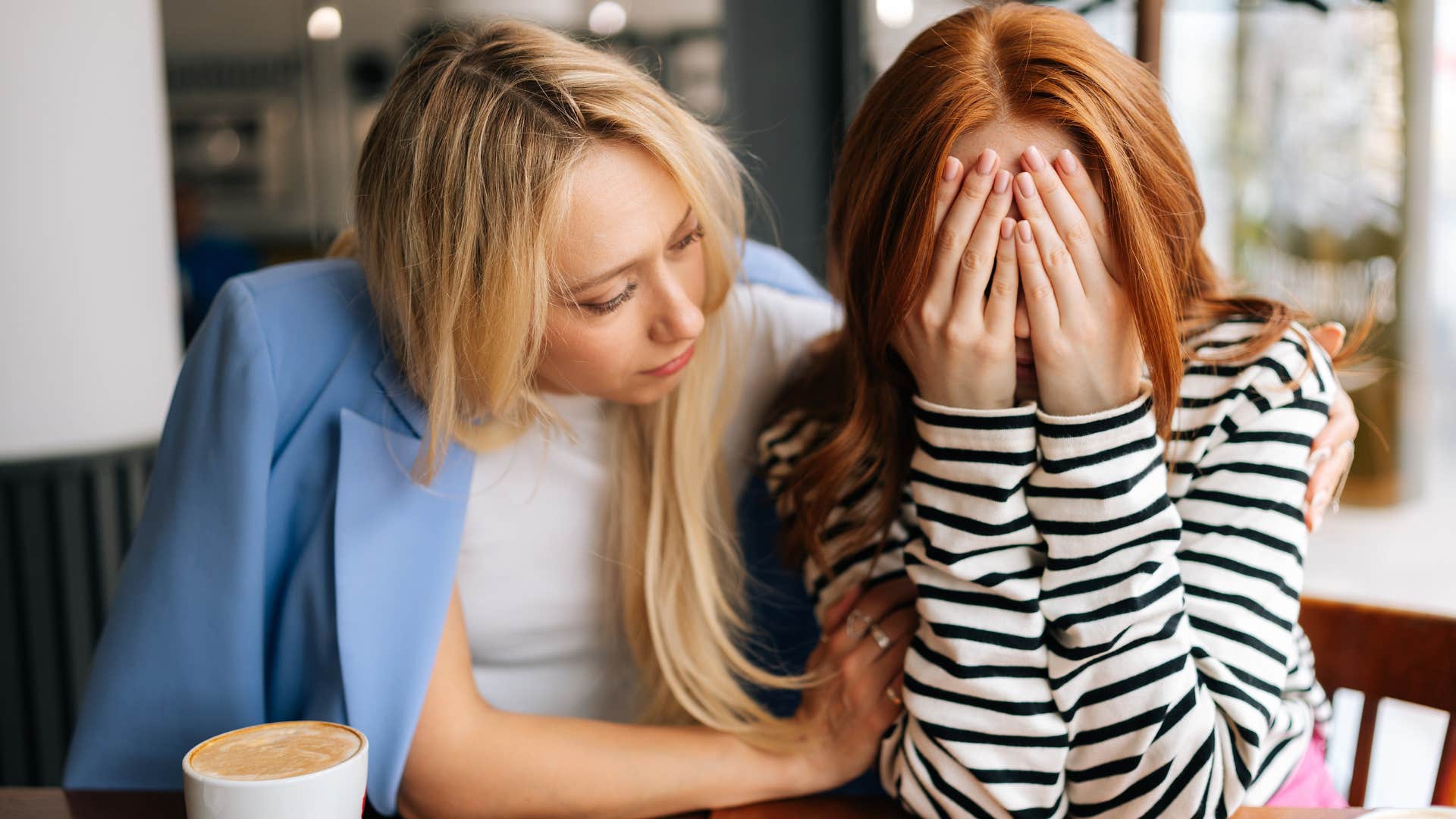 Upset woman saying "nobody understands me" while being comforted by a friend.
