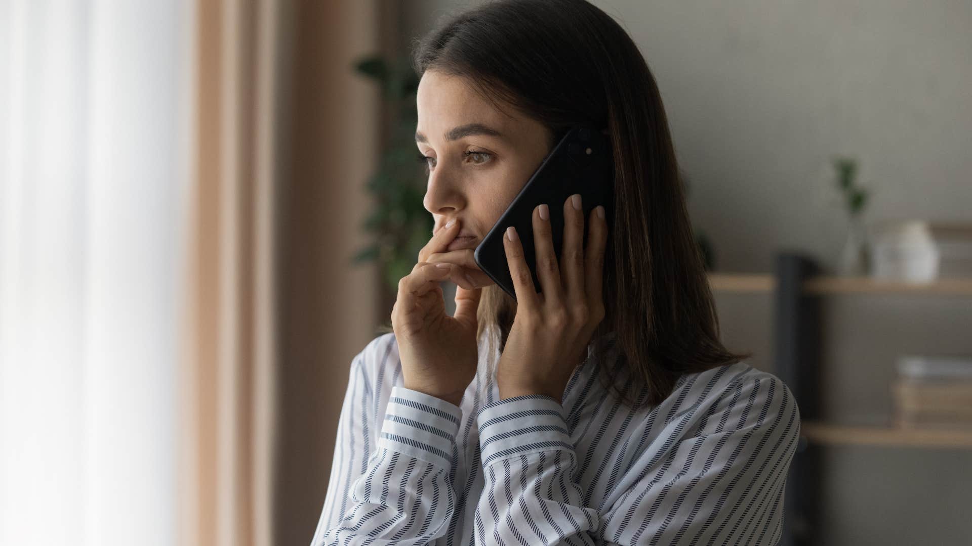 Upset woman saying "I know I won't like it" on the phone.
