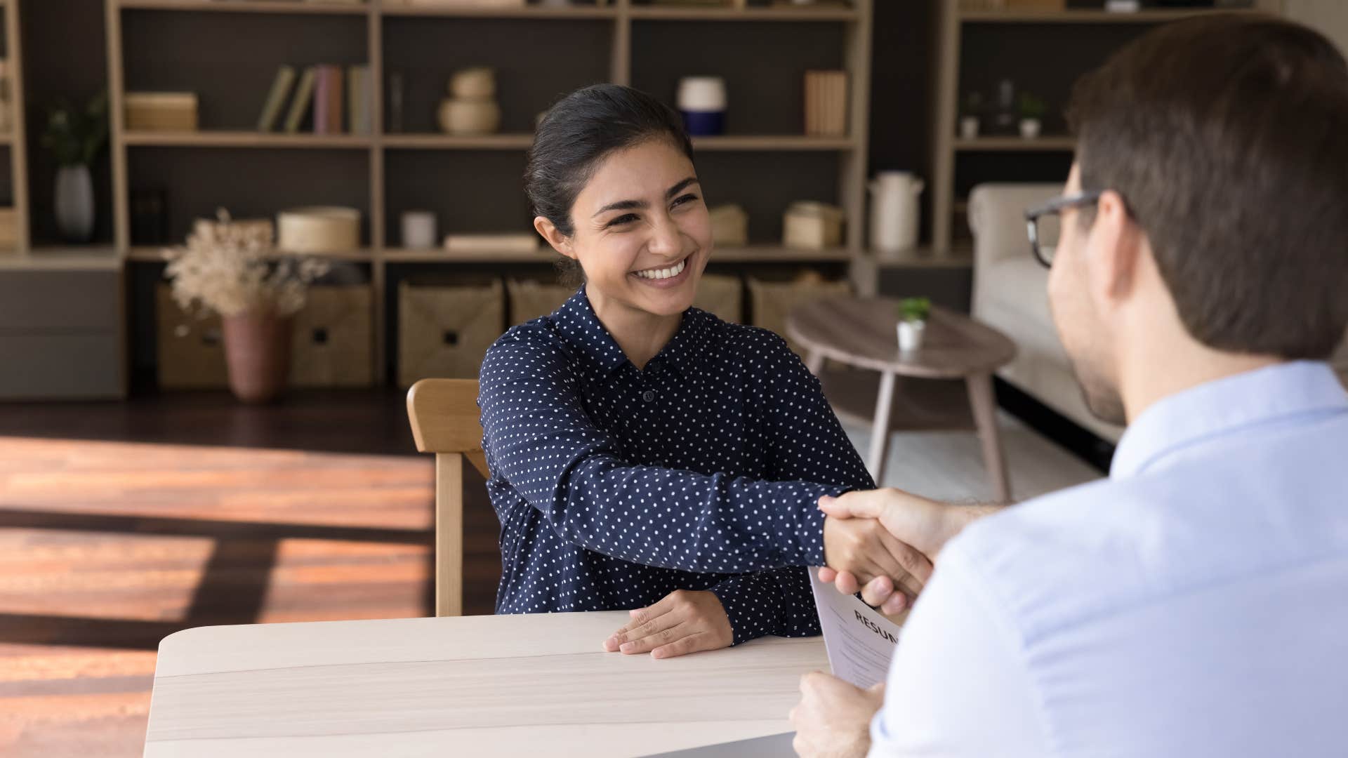 woman shaking man's hand telling him to keep his word
