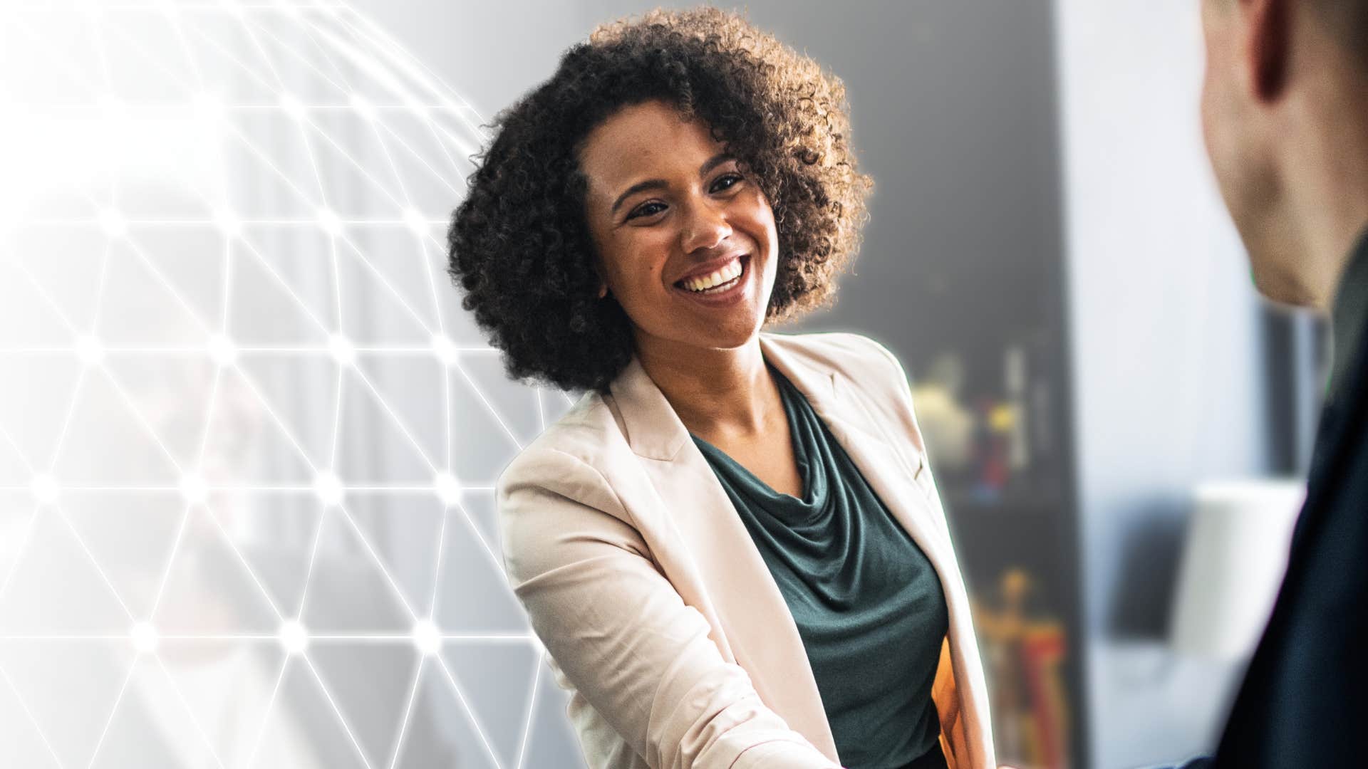woman shaking work colleague's hand telling them theyre surprisingly humble
