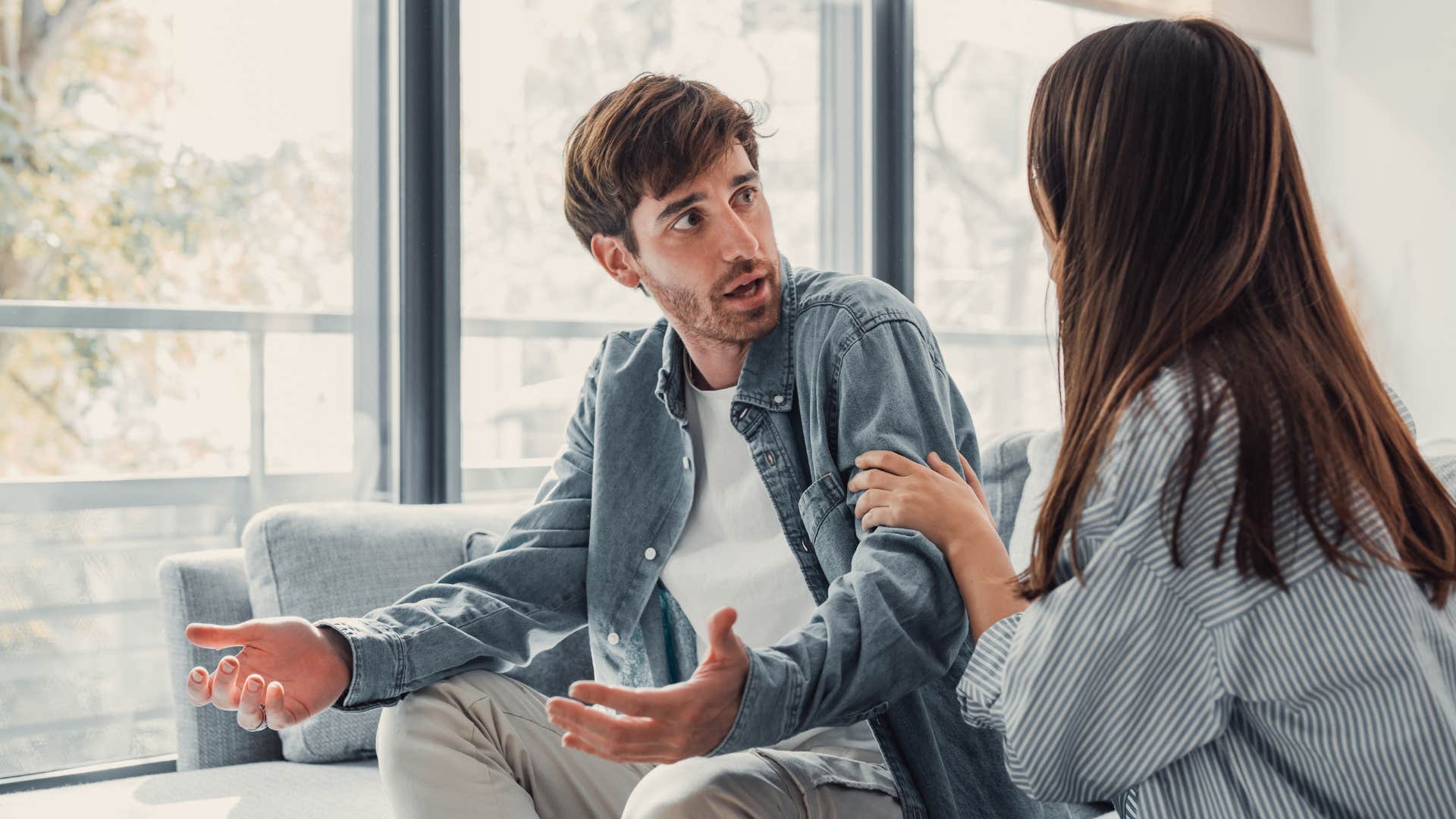 man in white shirt shrugging off woman as he says i don't have time for this right now