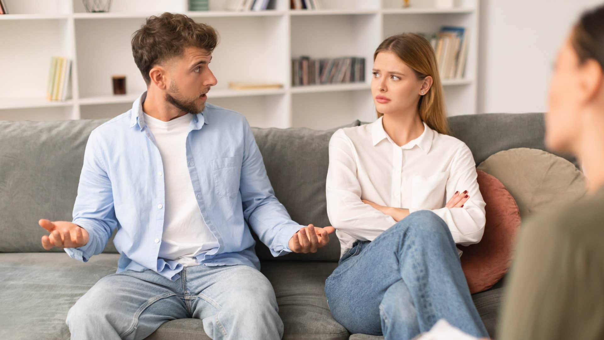 man in white shirt sitting down with woman at a therapy session and telling her she just needs to stop thinking so much