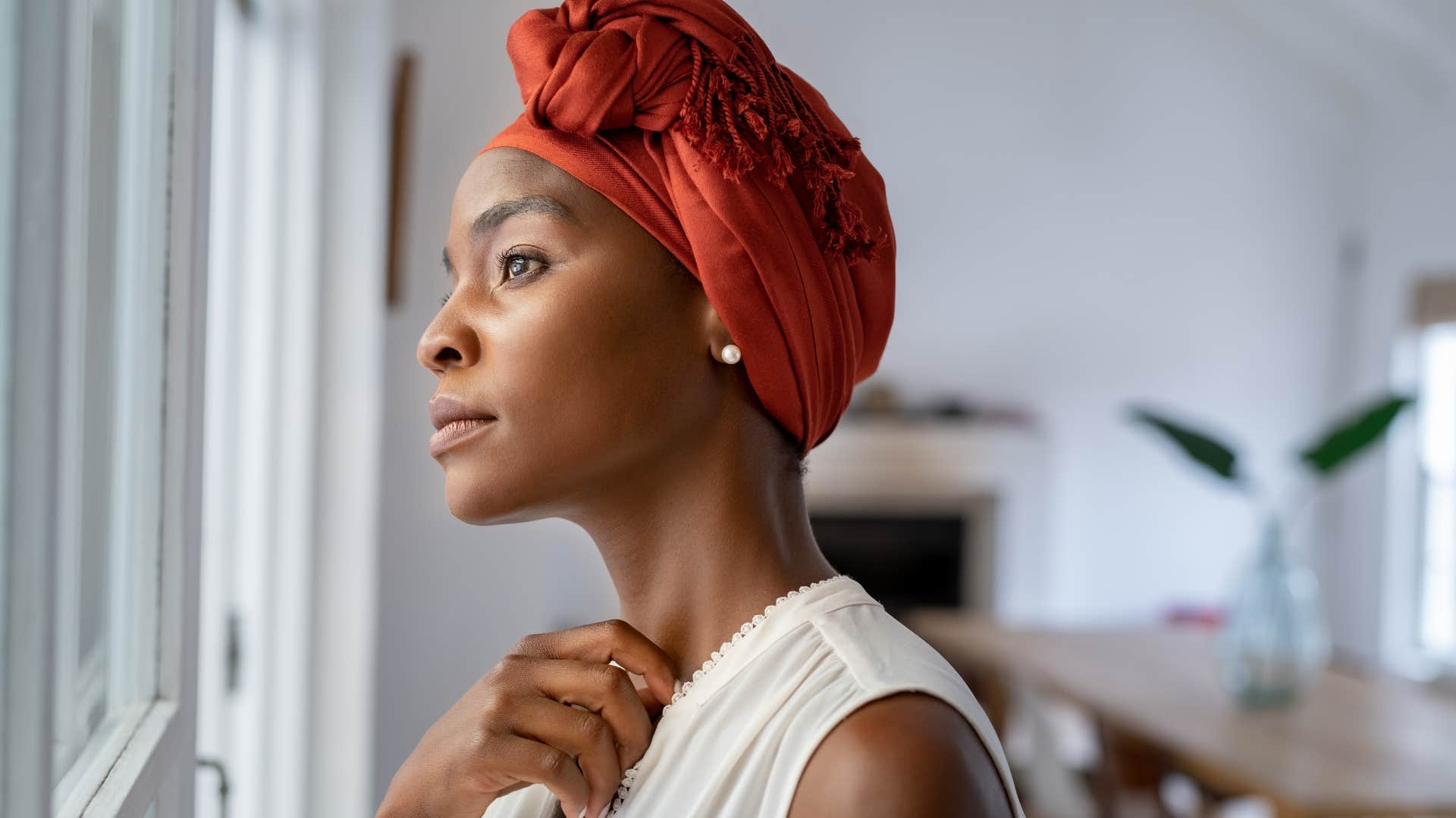 nostalgic woman who misses home looking out her window