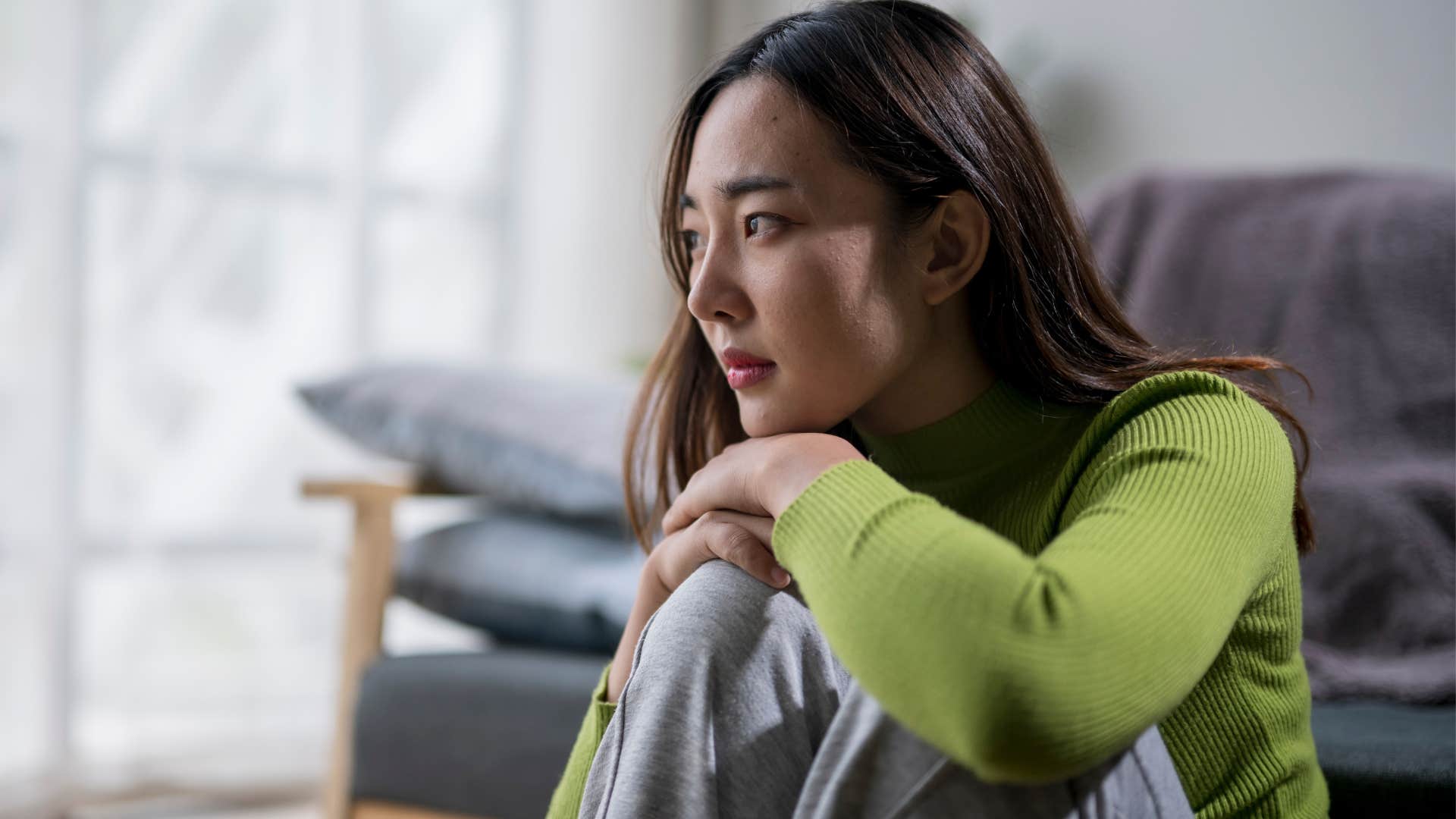 woman avoiding talking about her parents sitting at home