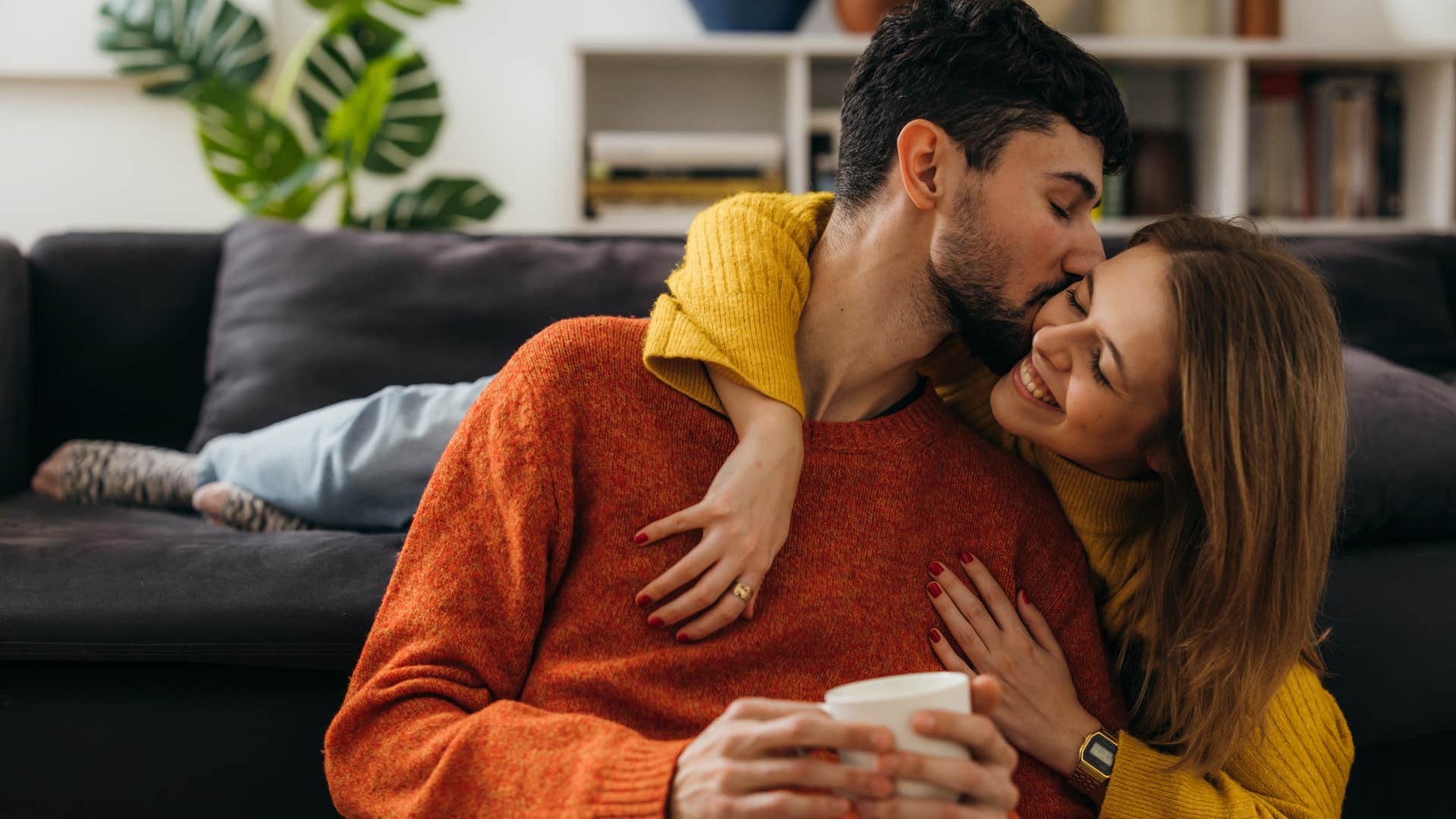 man kissing woman on cheek reminding her he loves her