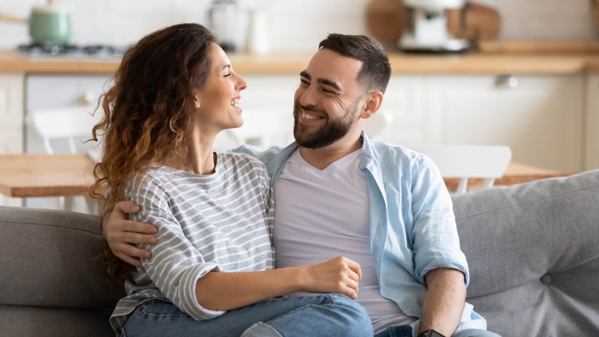 couple looking at each other while sitting down as they realize there's joy to be found in silence