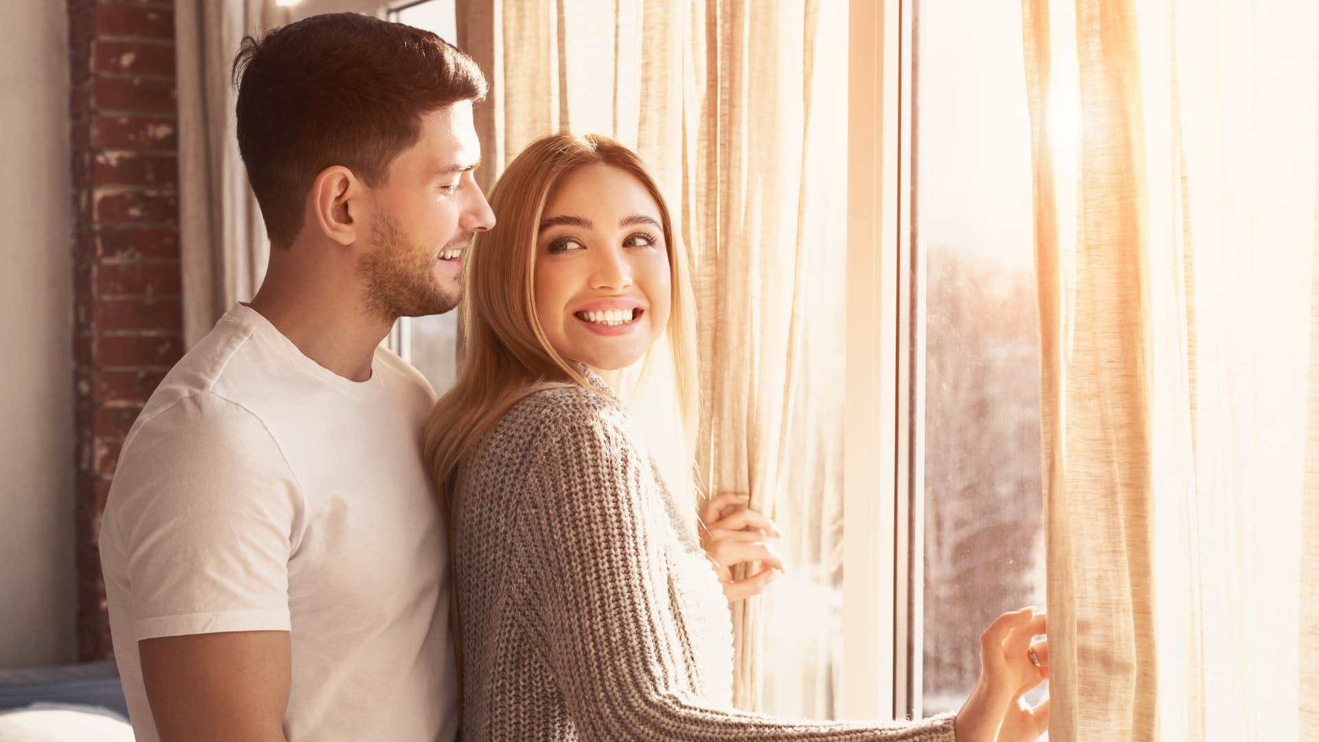 couple smiling and looking at each other as time feels different when they're together