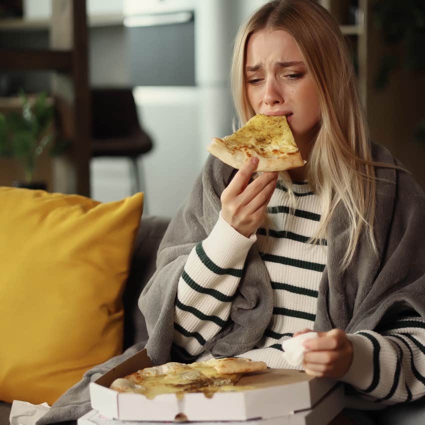 women feeling sad eating pizza