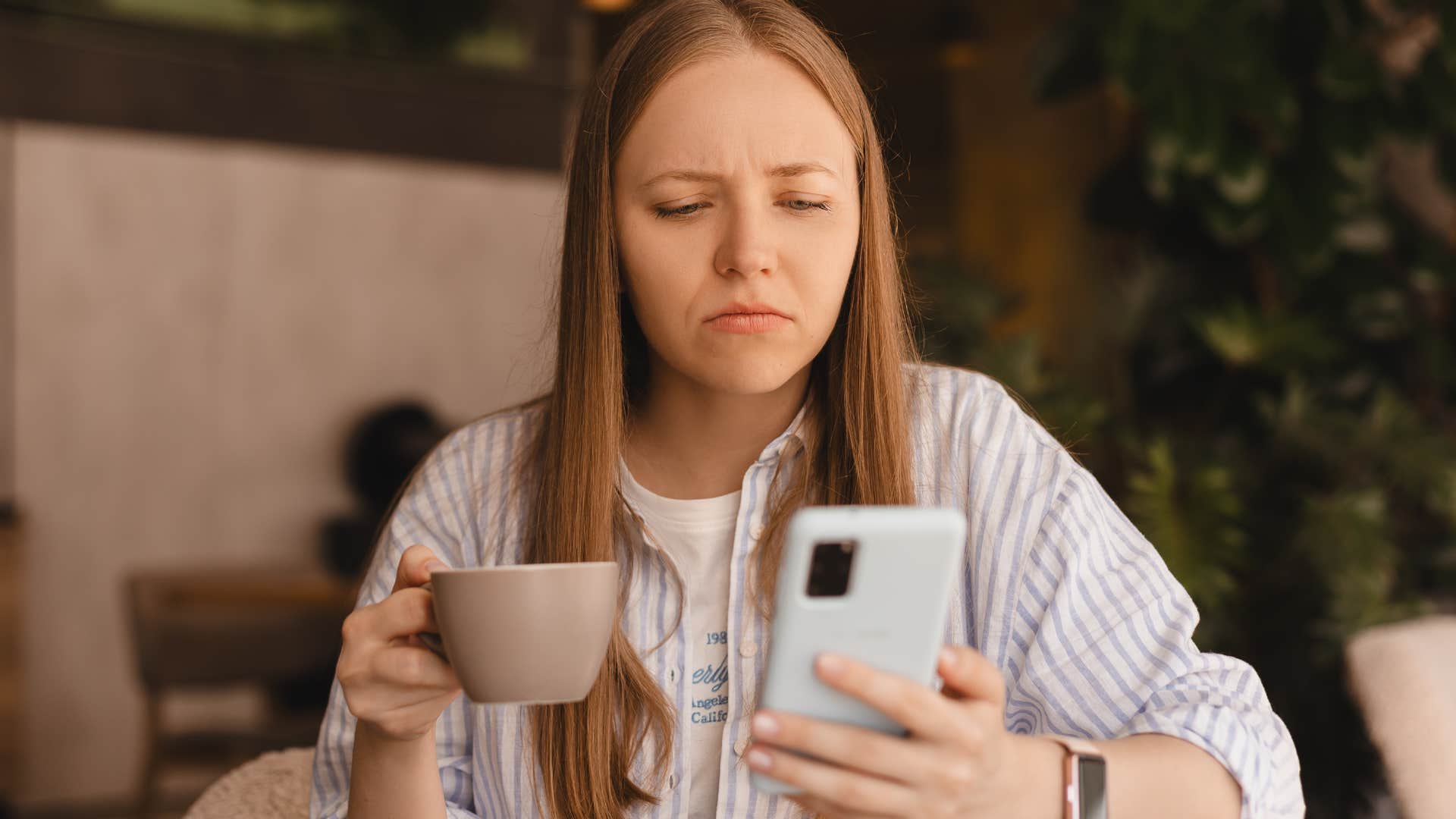 woman comparing herself to others online drinking coffee