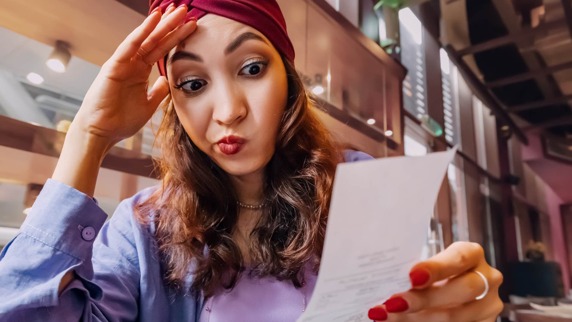 woman who regrets her purchases looking at a receipt