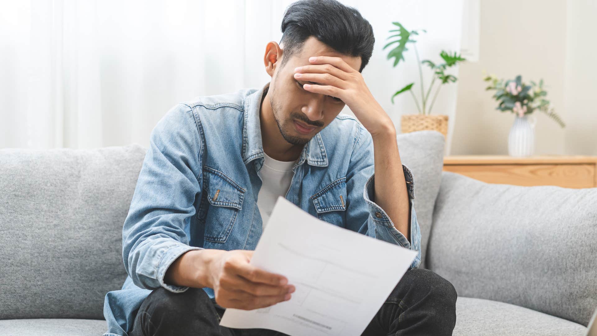 Man who can't afford healthcare doing bills.