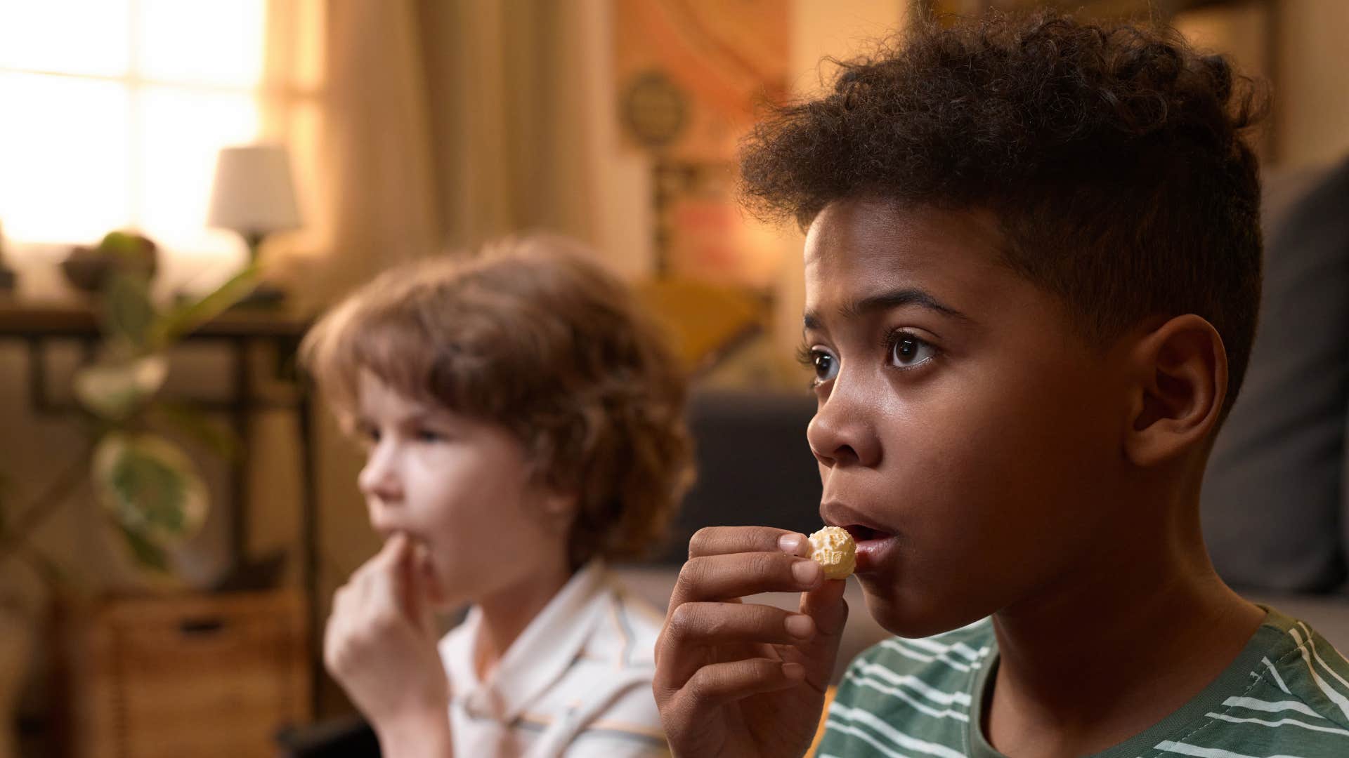 two gen x kids watch saturday morning cartoons after a sleepover