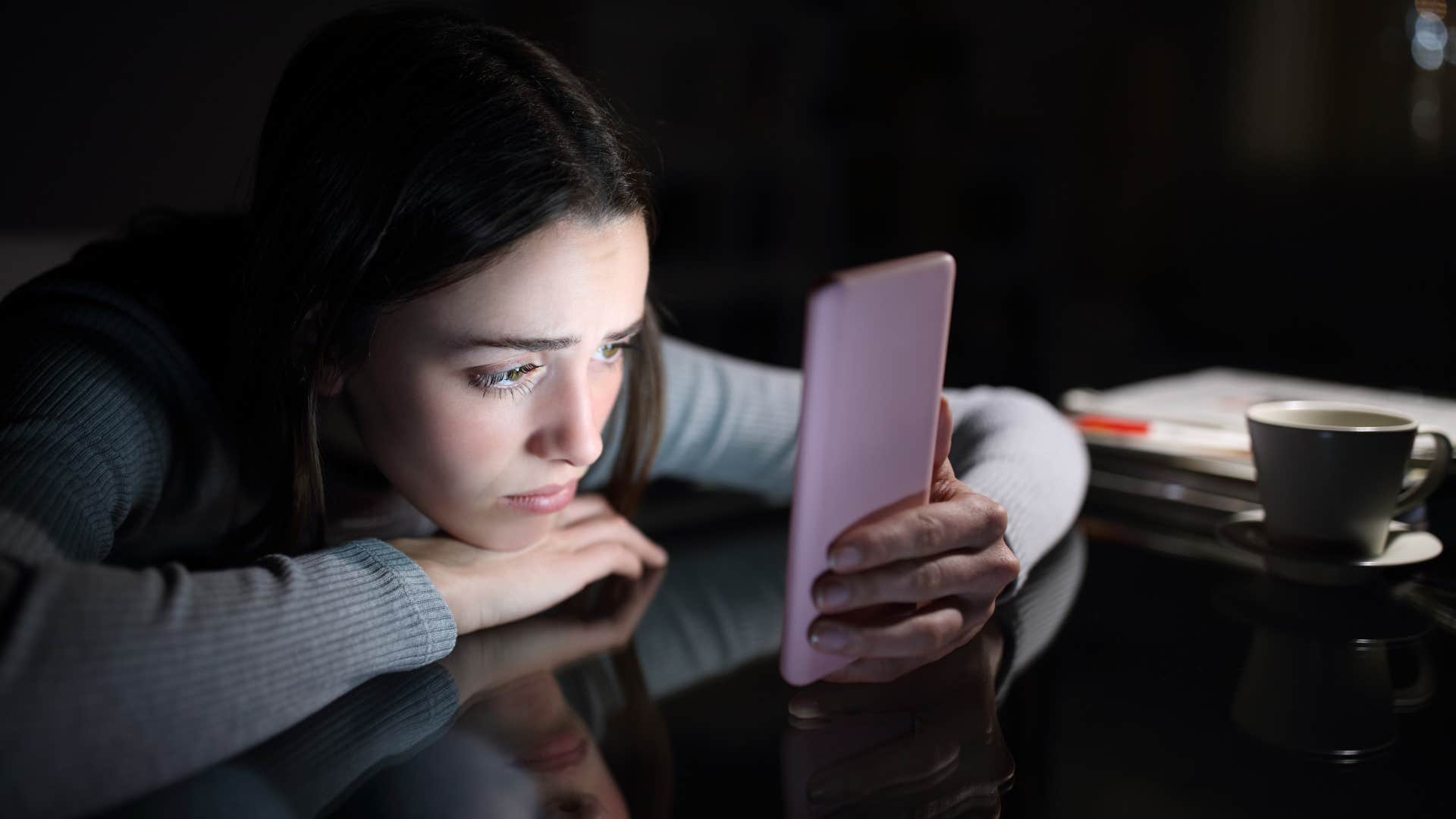 incredibly anxious woman doomscrolling at night