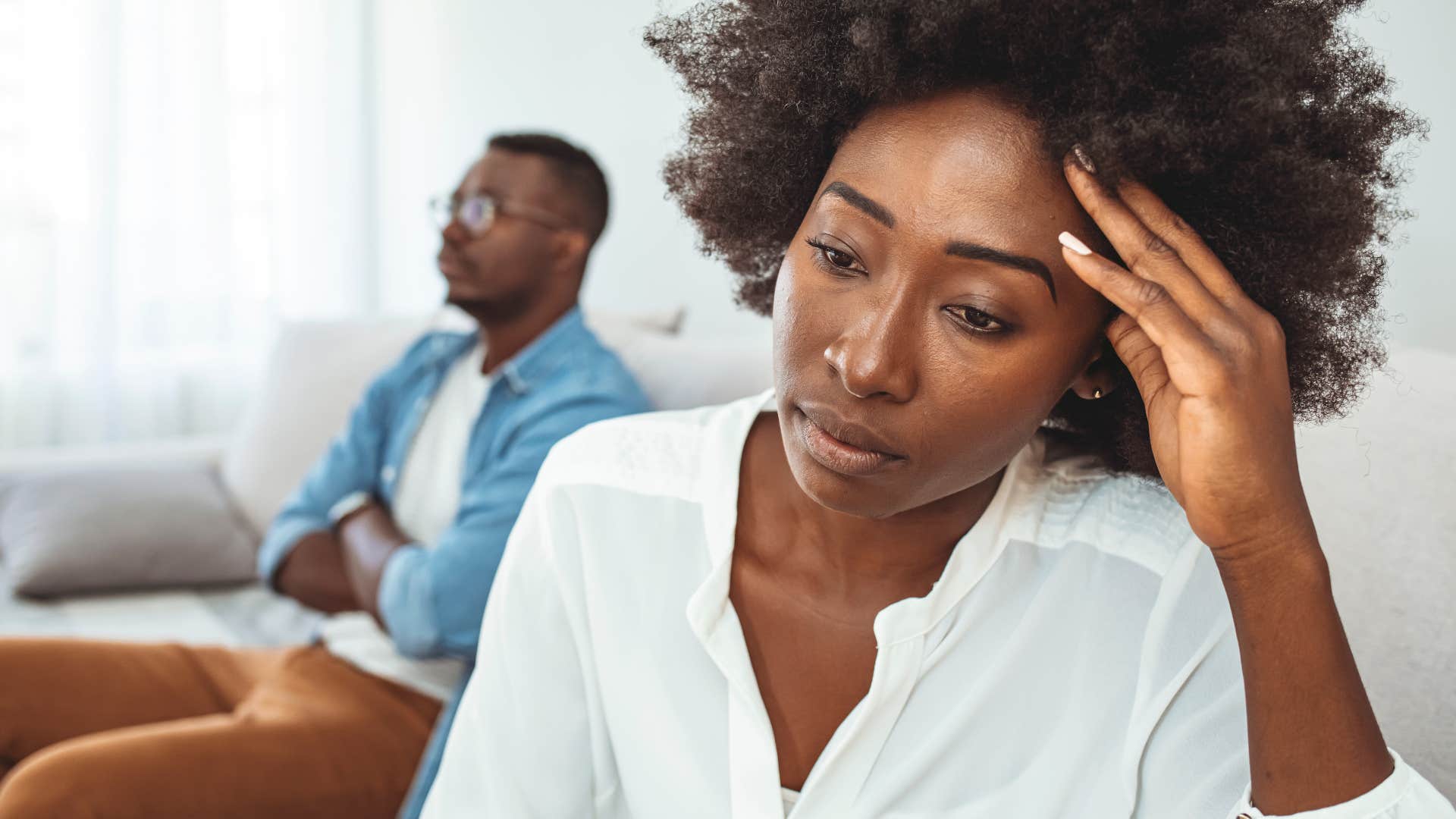 Upset woman accepting less than they deserve next to their partner.