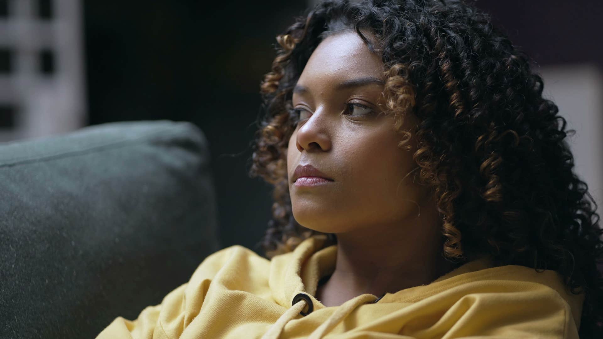Woman who wants a different life, but doesn't change, laying on her couch.