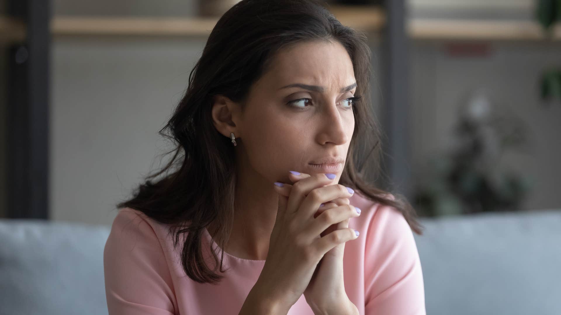 Woman who's emotionally numb looking away from the camera.