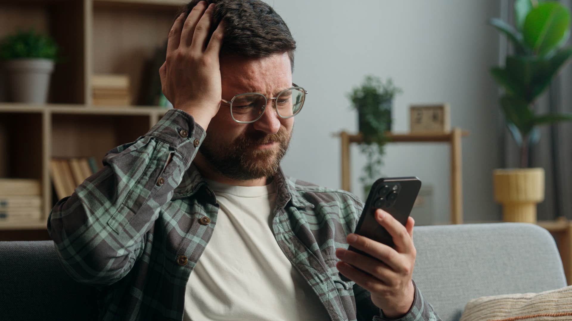 Man wasting time while scrolling on his phone.