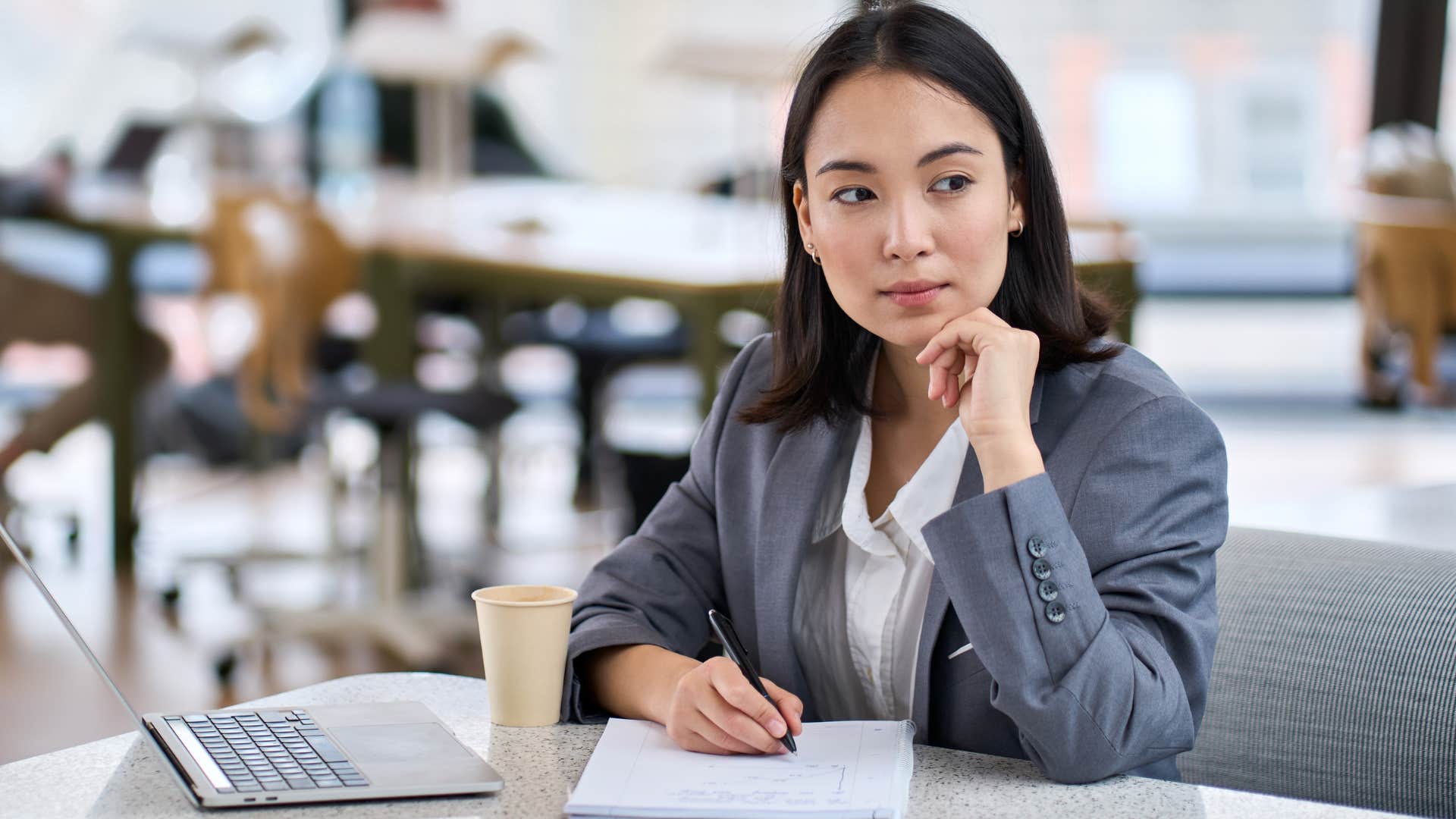 woman who was told how to feel growing up looking around at work