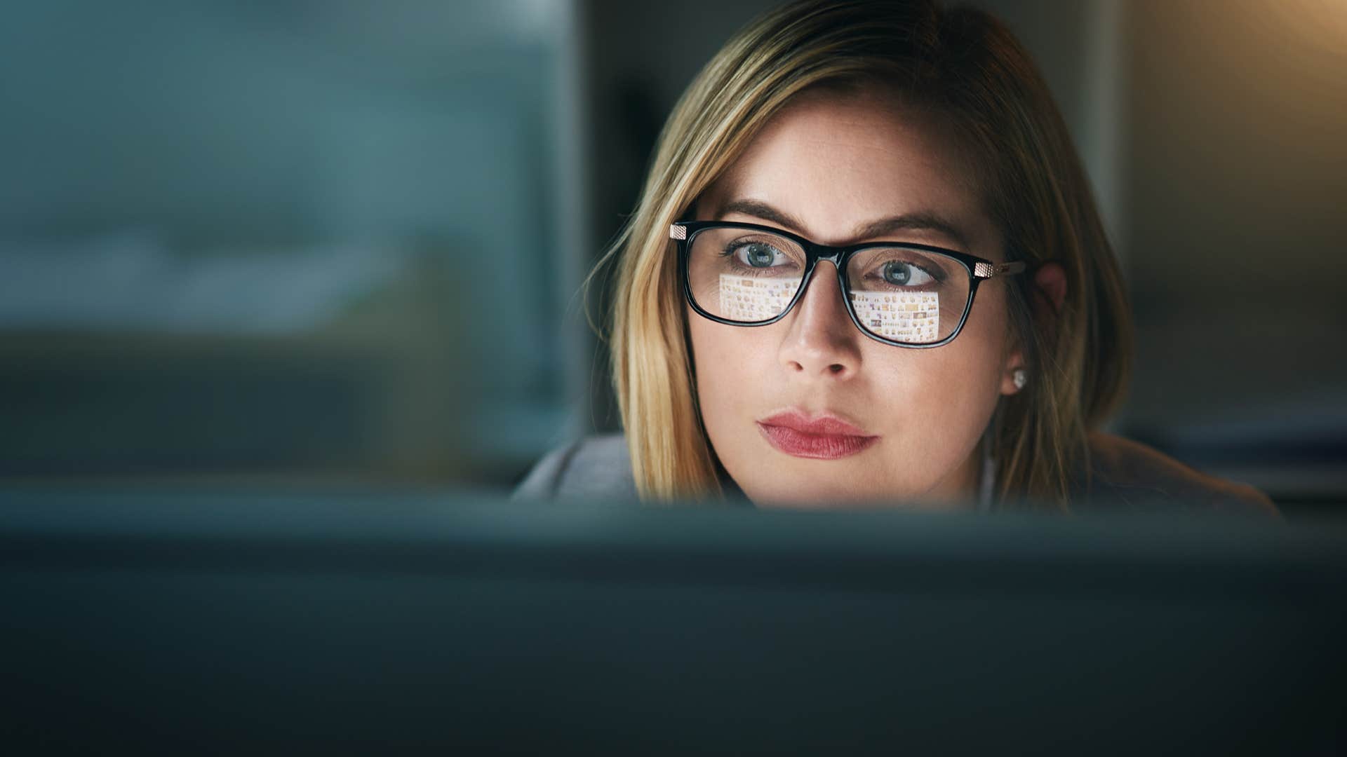 woman whose parents weaponized shame working on her laptop