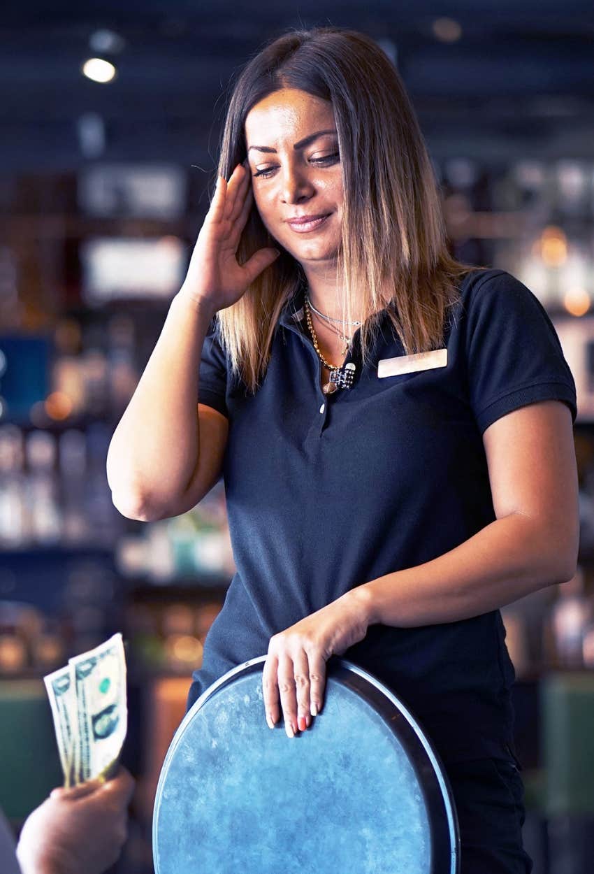 uncomfortable server being offered a tip for being pretty