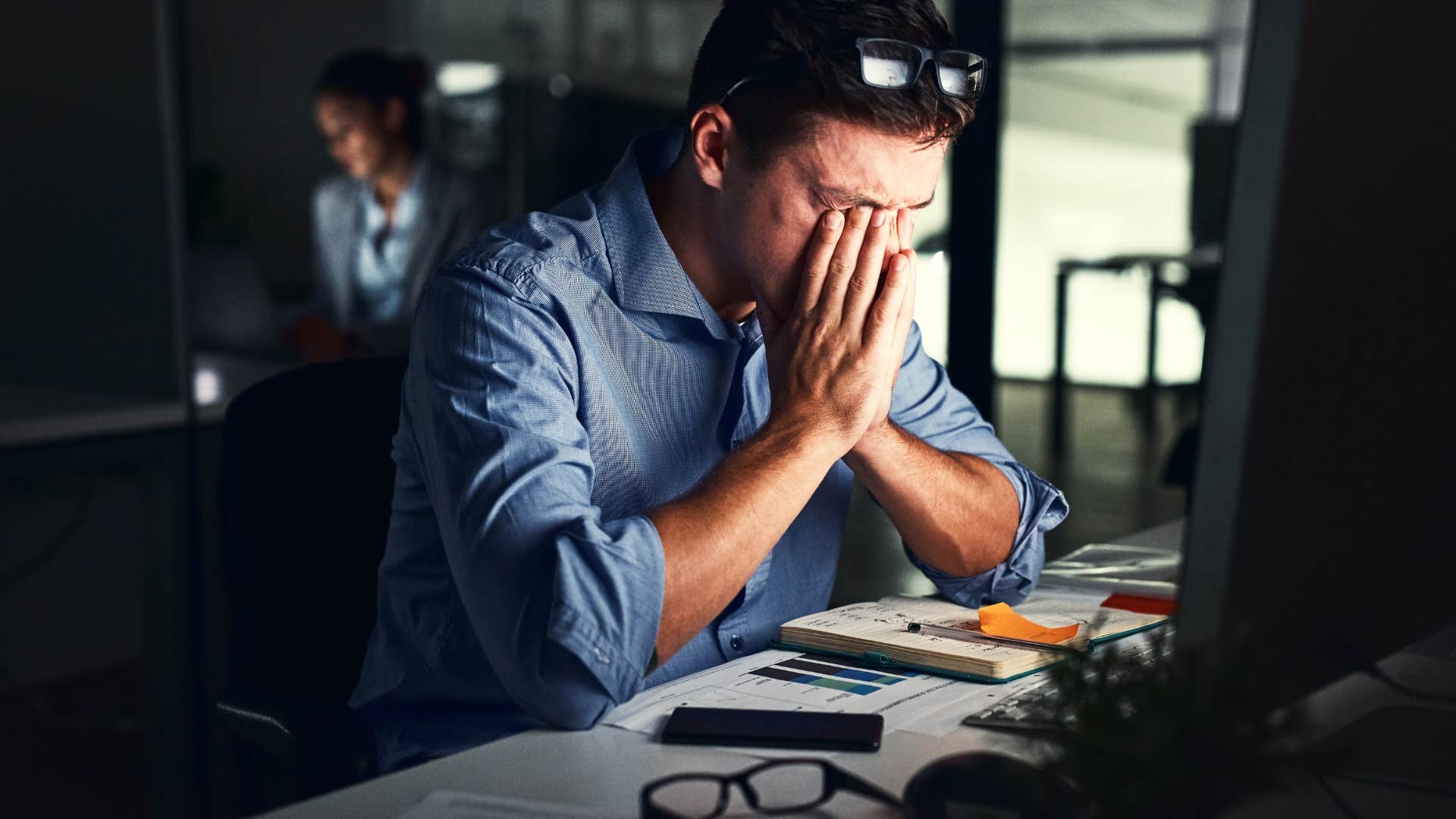 man who's busyness is turning toxic overwhelmed by addiction to work