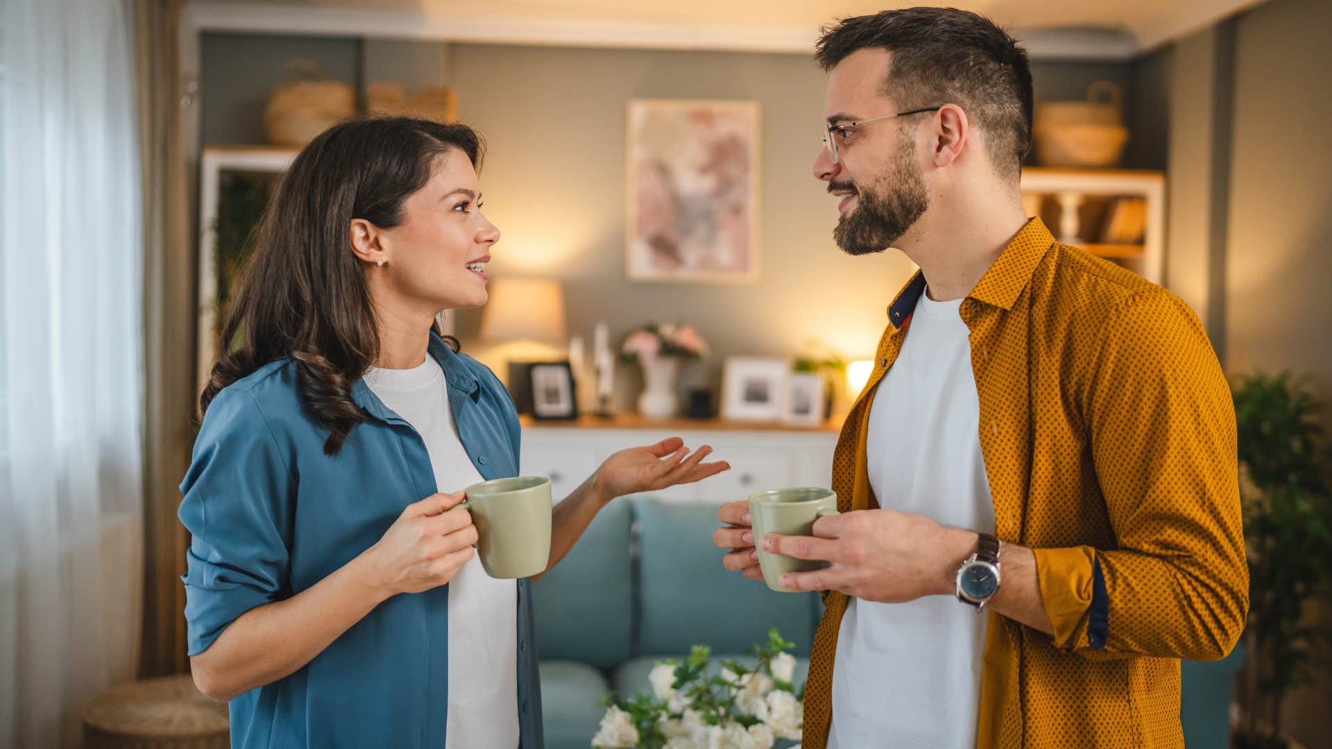 woman always the one initiating conversations as she and man talk while drinking coffee