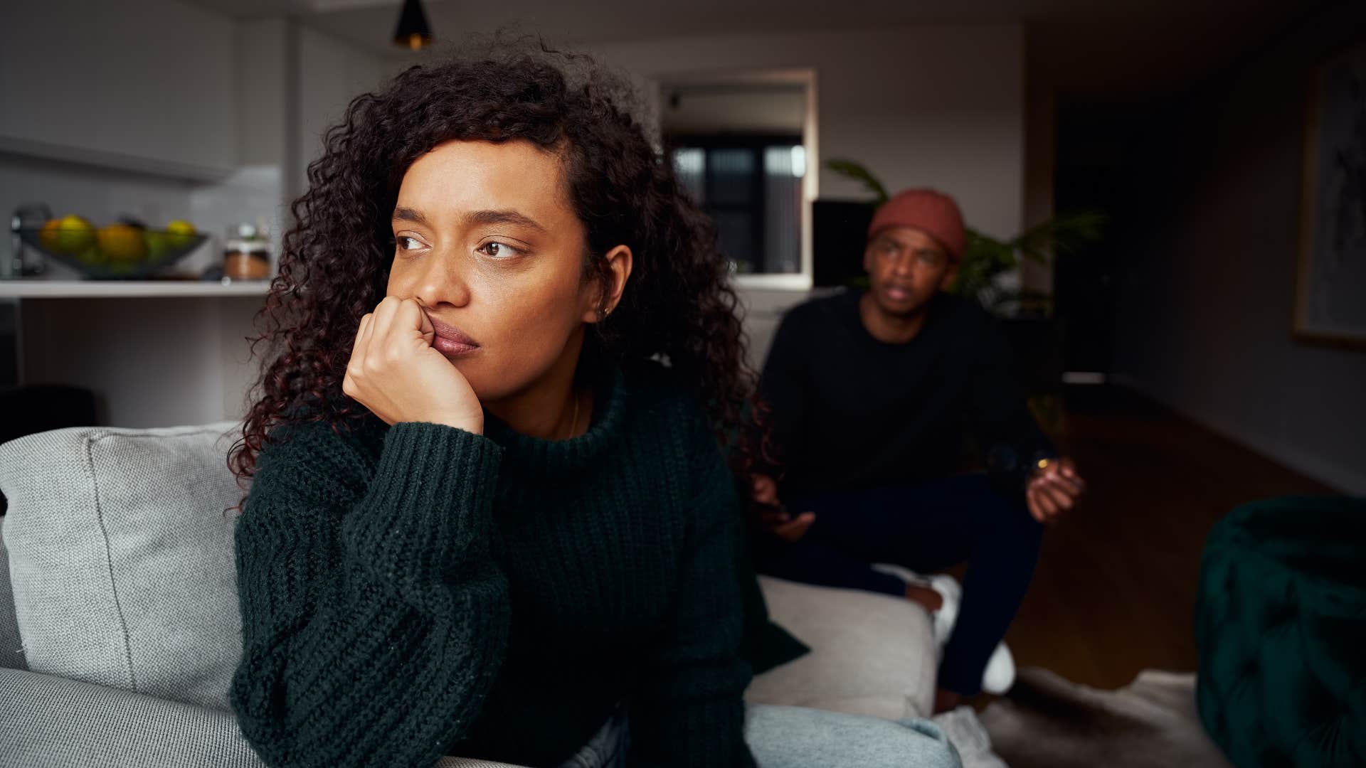 woman in green shirt no longer craving connection and affection as she ignores man talking to her