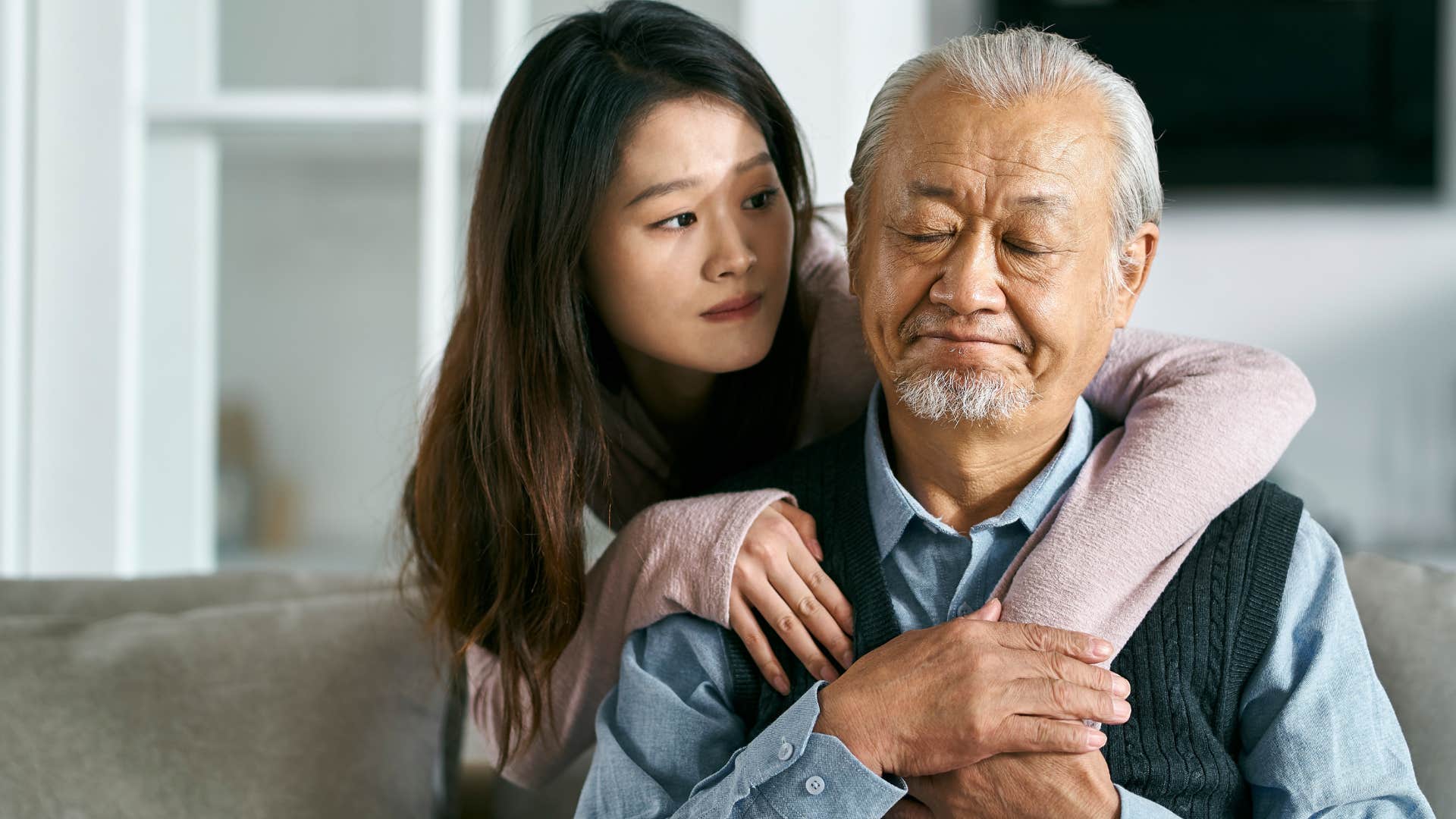 Woman who's a caregiver hugging her father.